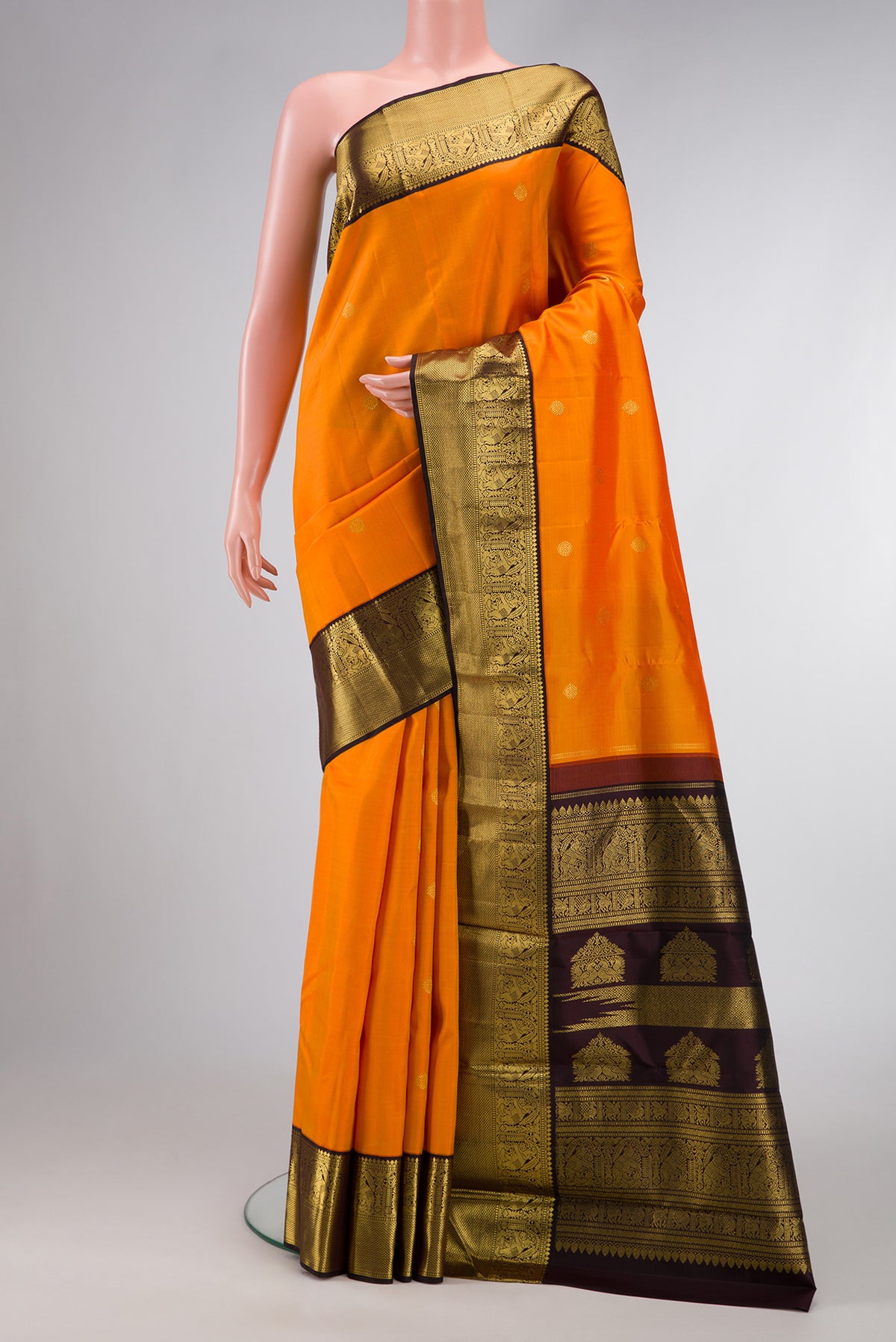 Mustard Dual Tone Kanjivaram Silk Saree with Zari Butta on the body and Zari Border.  displayed on a mannequin