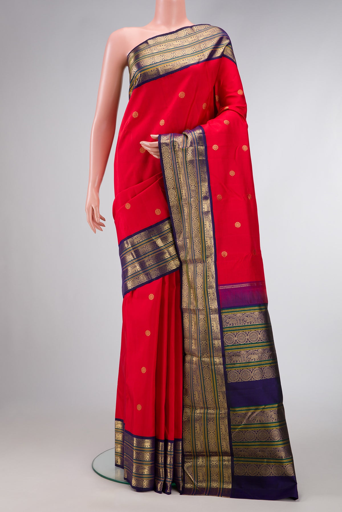 Red Dual Tone Kanjivaram Silk Saree with Zari Butta on the body and Zari Border.  displayed on a mannequin