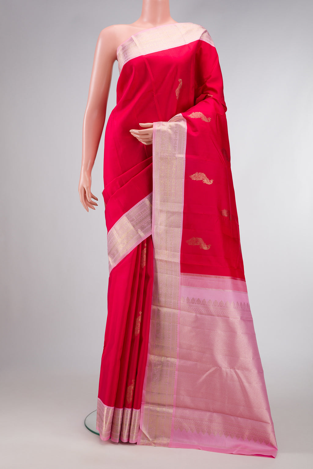 Red Dual Tone Kanjivaram Silk Saree with Zari Butta on the body and Zari Border.  displayed on a mannequin