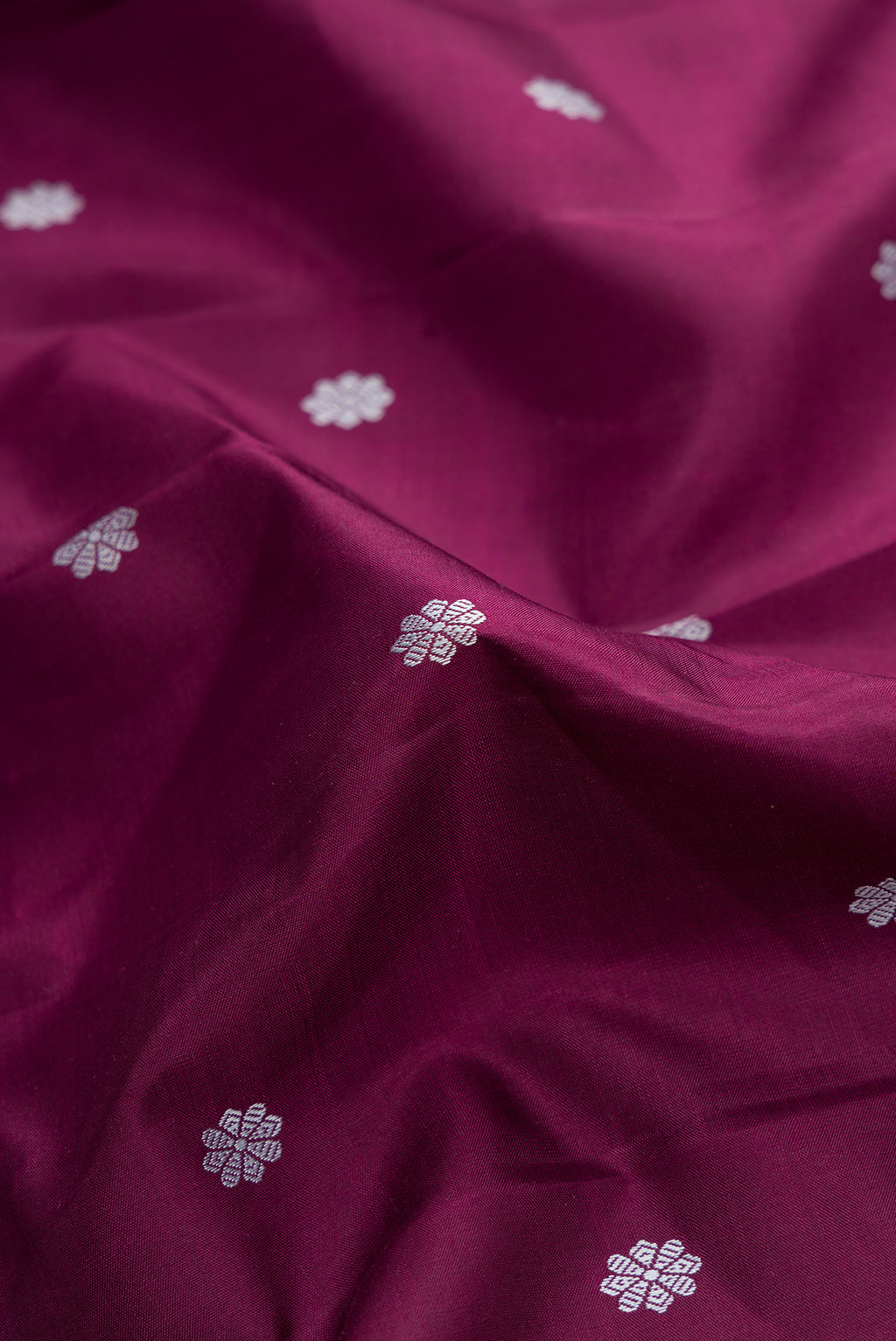Close up of Pure Silk Pure Zari Brown Dual Tone Kanjivaram Saree with Thread Butta on the body and Zari Border.  displaying folds