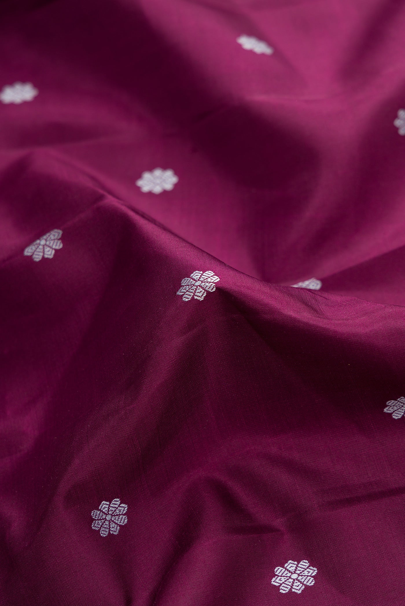 Close up of Pure Silk Pure Zari Brown Dual Tone Kanjivaram Saree with Thread Butta on the body and Zari Border.  displaying folds