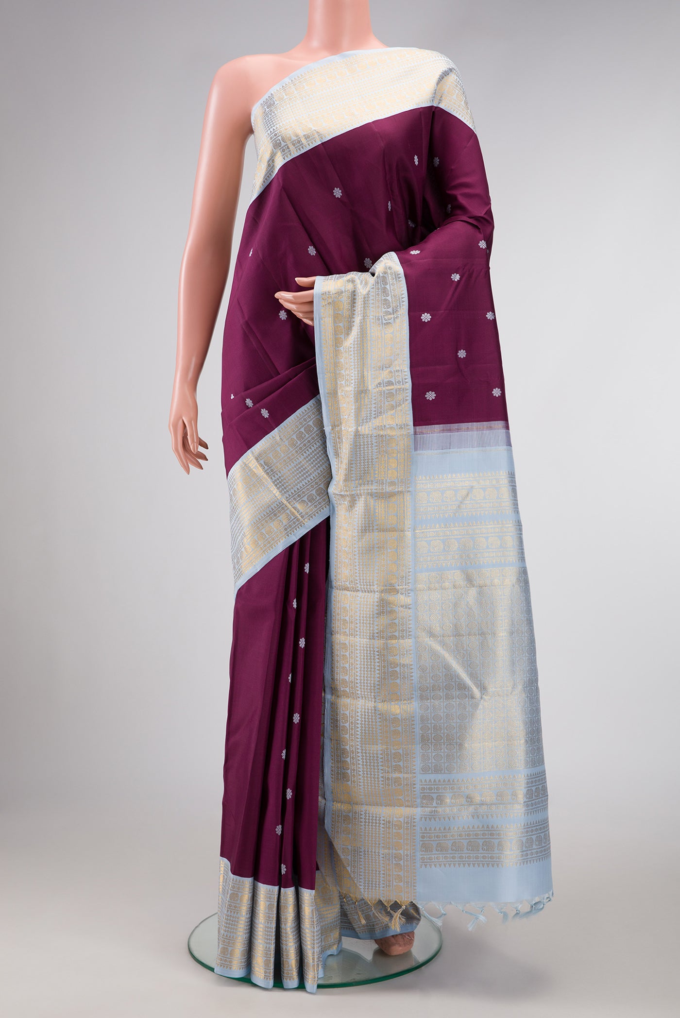 Pure Silk Pure Zari Brown Dual Tone Kanjivaram Saree with Thread Butta on the body and Zari Border.  displayed on a mannequin