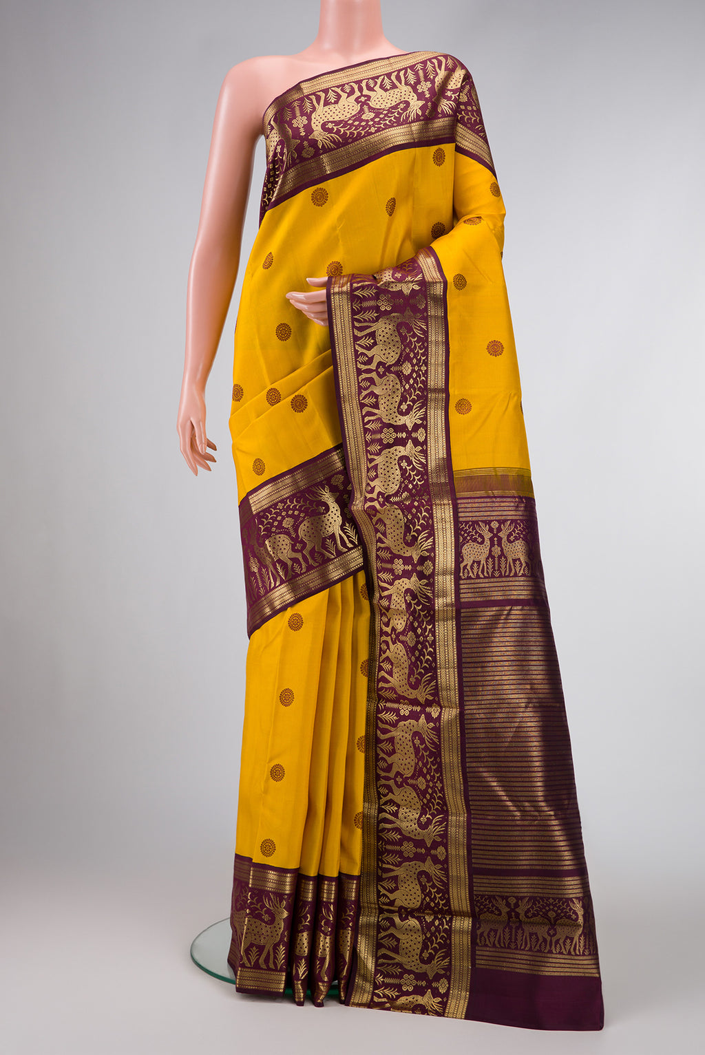 Mustard Dual Tone Kanjivaram Silk Saree with Thread Butta on the body and Fancy Border.  displayed on a mannequin