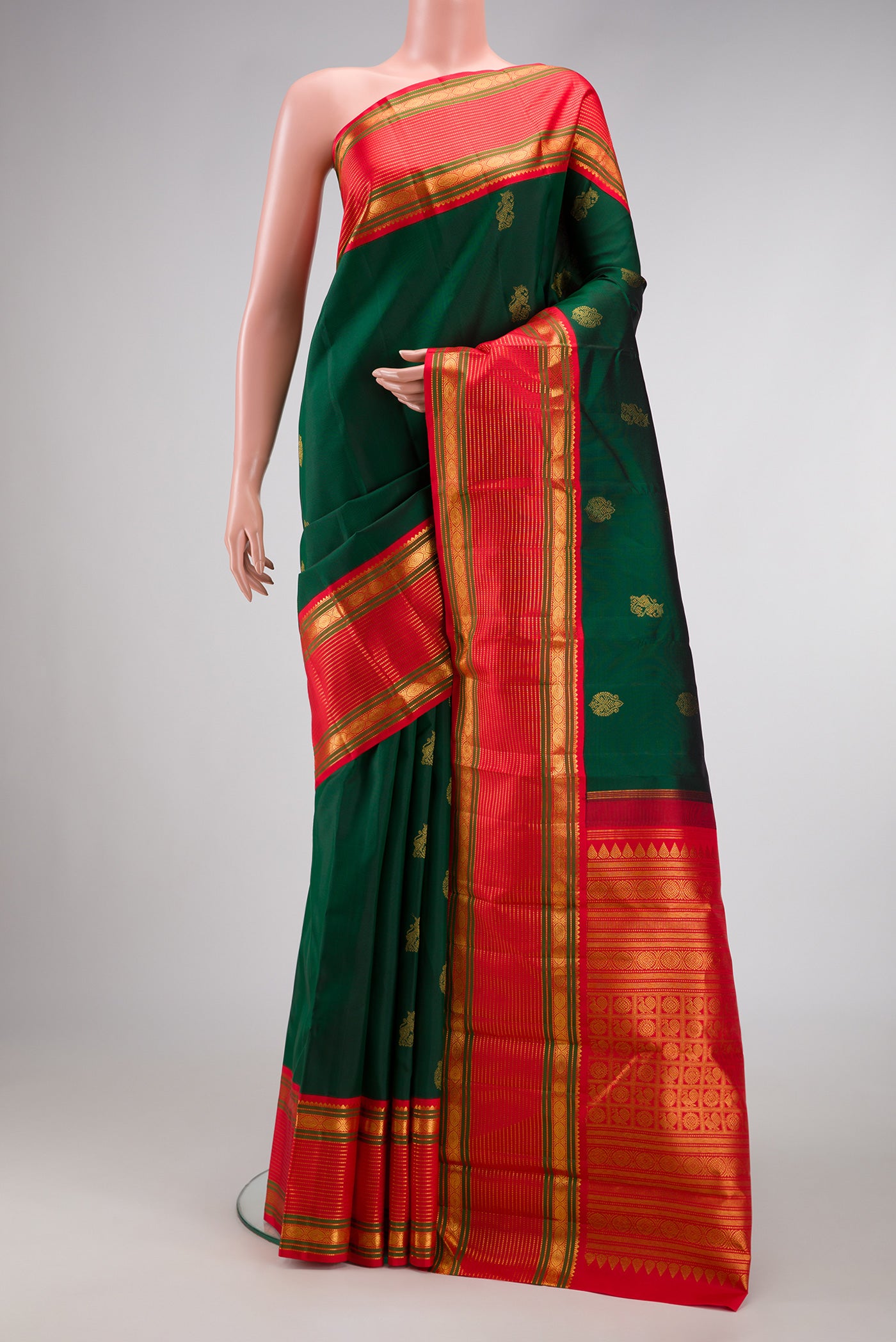 Pure Silk Pure Zari Green Dual Tone Kanjivaram Saree with Zari Butta on the body and Zari Border.  displayed on a mannequin