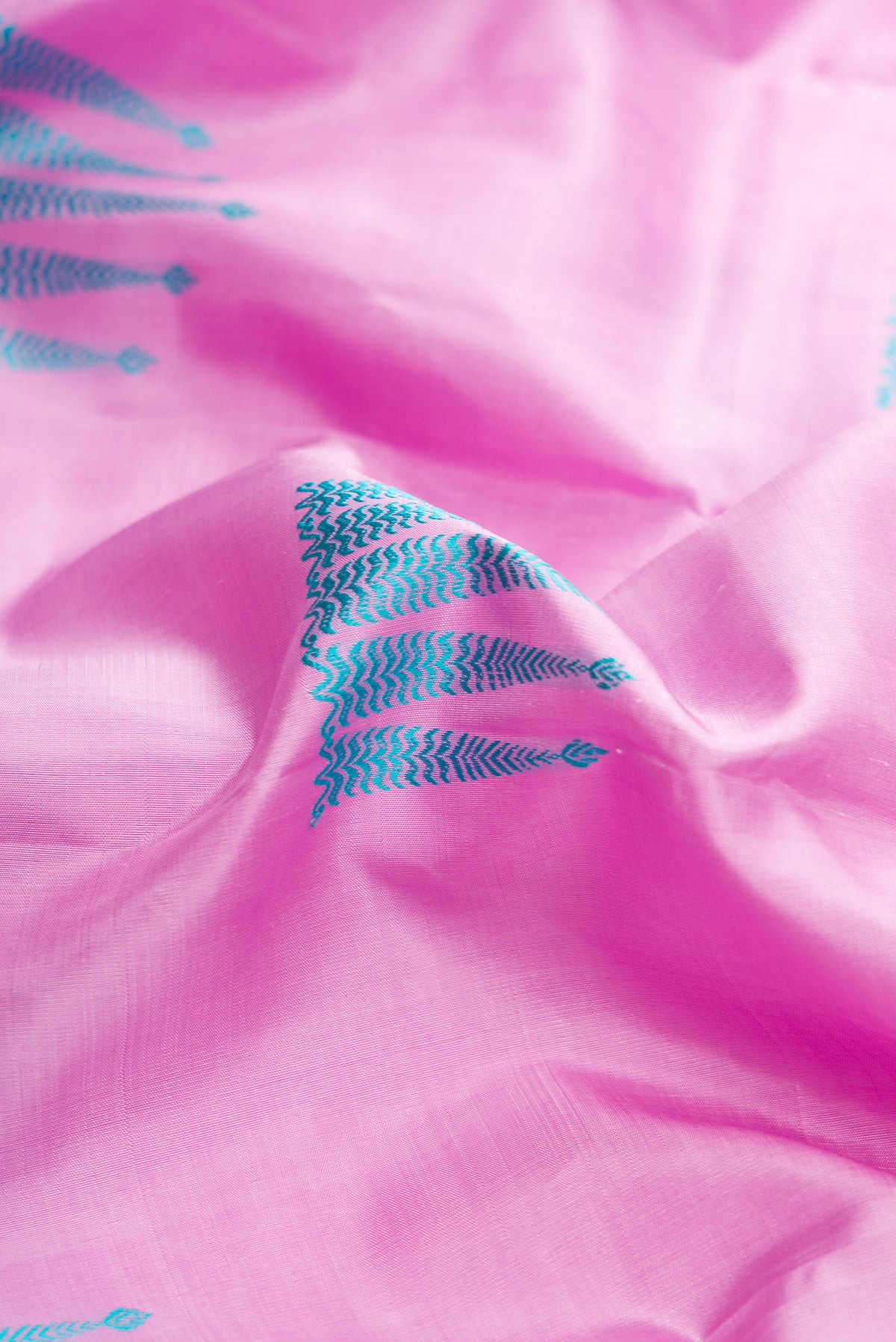 Close up of Pure Silk Pure Zari Pink Dual Tone Kanjivaram Saree with Thread Butta on the body and Zari Border.  displaying folds