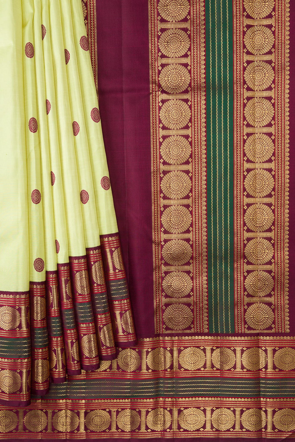 Pleats and pallu of Pure Silk Pure Zari Parrot Green Dual Tone Kanjivaram Saree with Thread Butta on the body and Zari Border. 