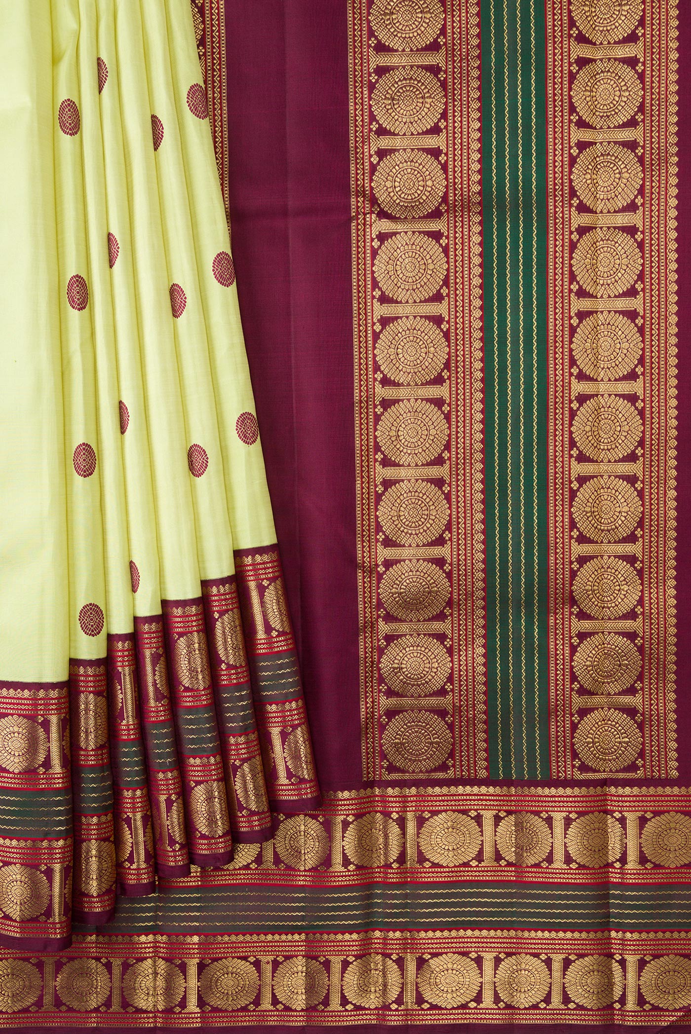 Pleats and pallu of Pure Silk Pure Zari Parrot Green Dual Tone Kanjivaram Saree with Thread Butta on the body and Zari Border. 