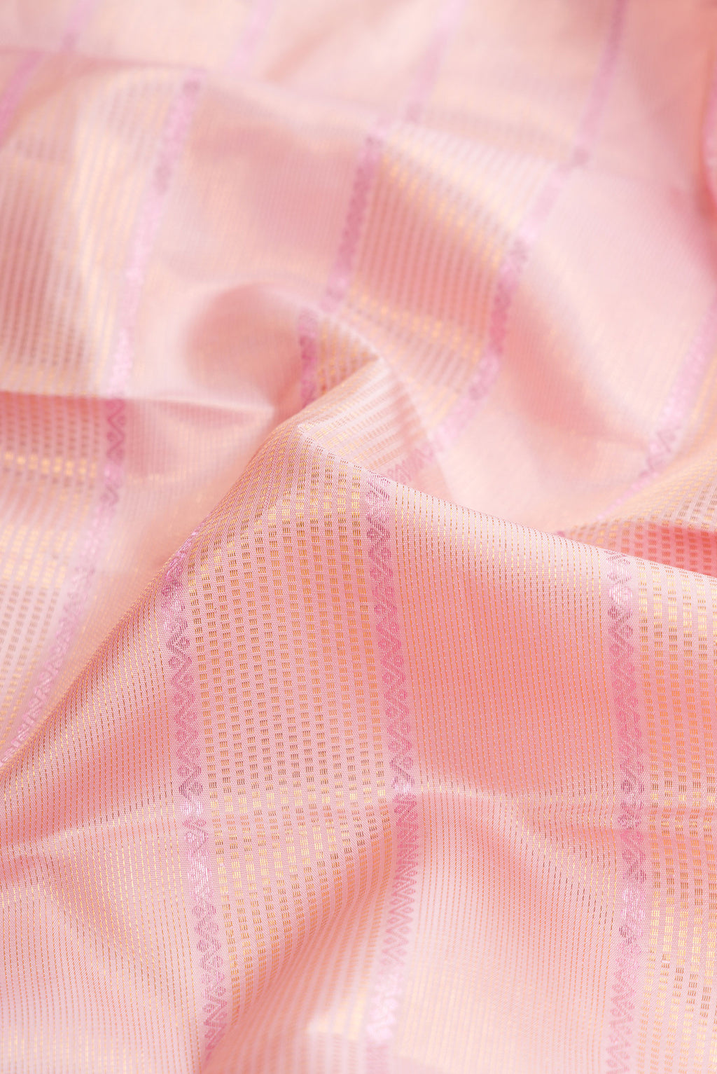 Close up of Pink Dual Tone Kanchipuram Silk Saree with Checked design on the body and Zari Border.  displaying folds