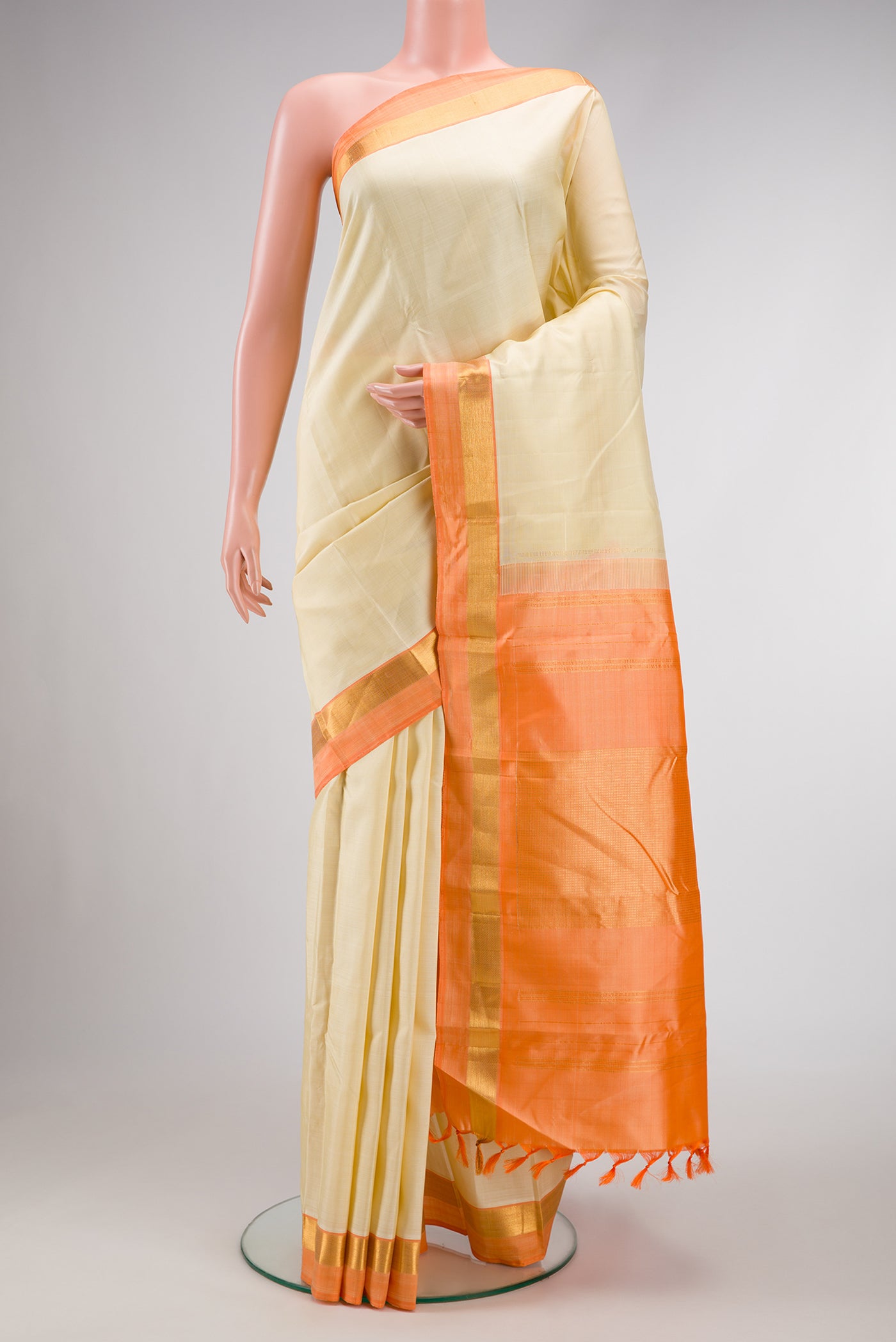 Sandal Dual Tone Kanjivaram Silk Saree with Plain Body and Zari Border.  displayed on a mannequin