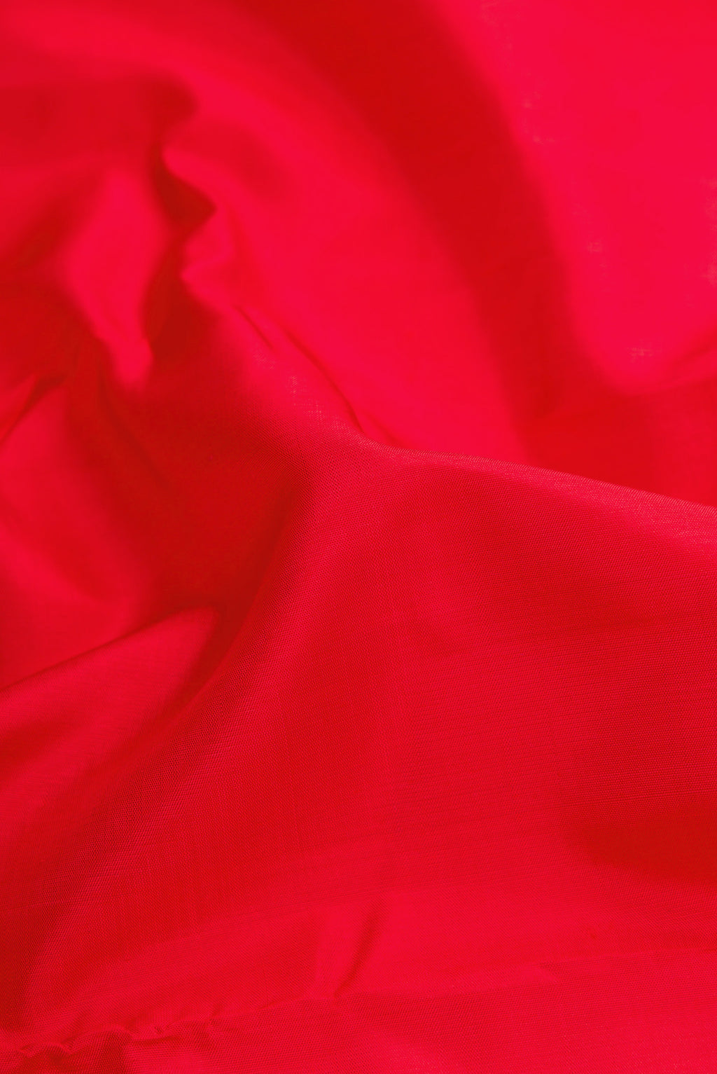 Close up of Red Dual Tone Kanjivaram Silk Saree with Plain Body and Zari Border.  displaying folds