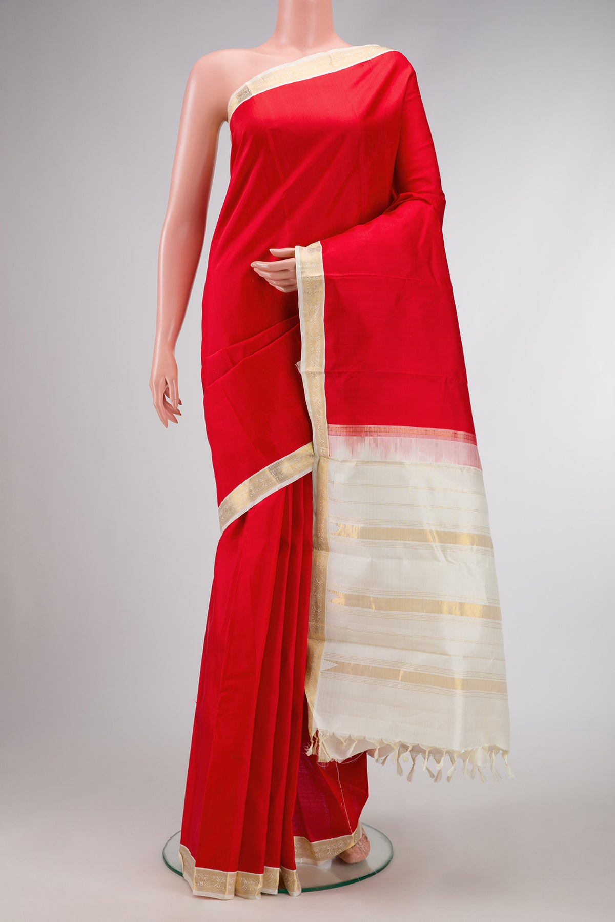Red Dual Tone Kanjivaram Silk Saree with Plain Body and Zari Border.  displayed on a mannequin