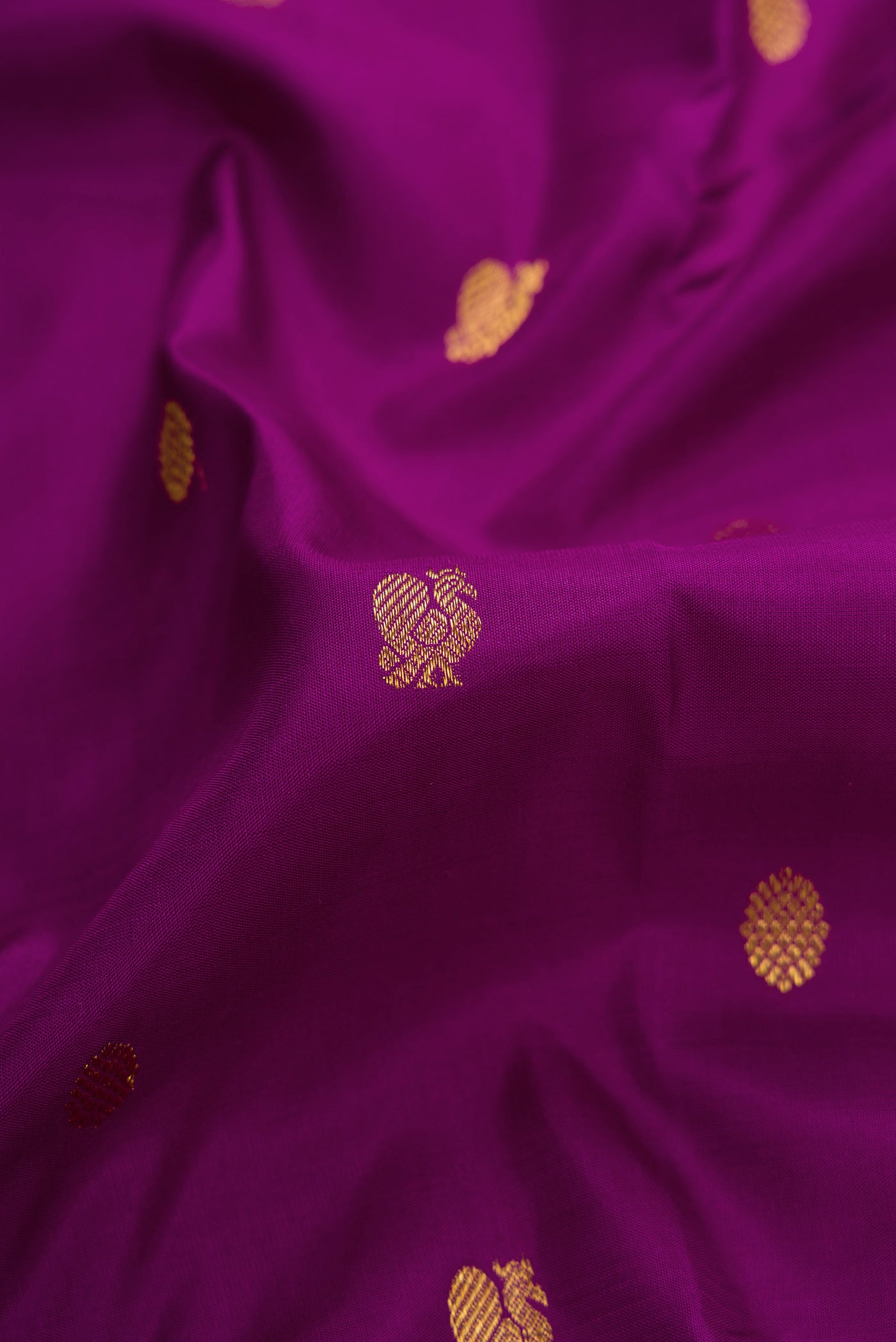 Close up of Purple Dual Tone Kanjivaram Silk Saree with Zari Butta on the body and Zari Border.  displaying folds