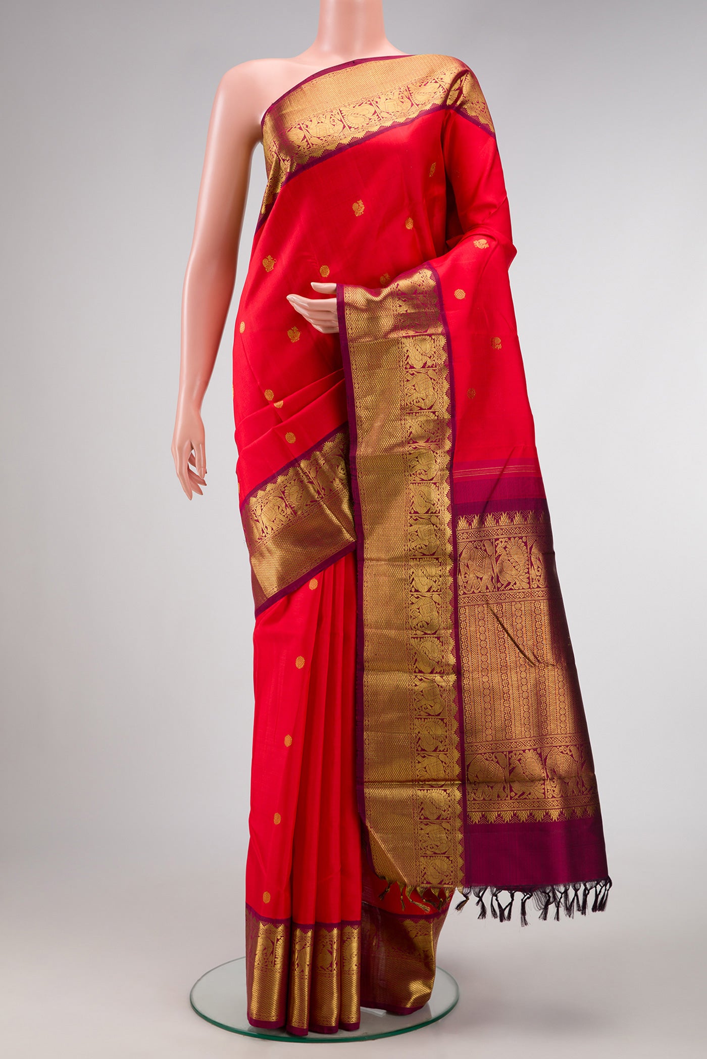Red Dual Tone Kanjivaram Silk Saree with Zari Butta on the body and Zari Border.  displayed on a mannequin