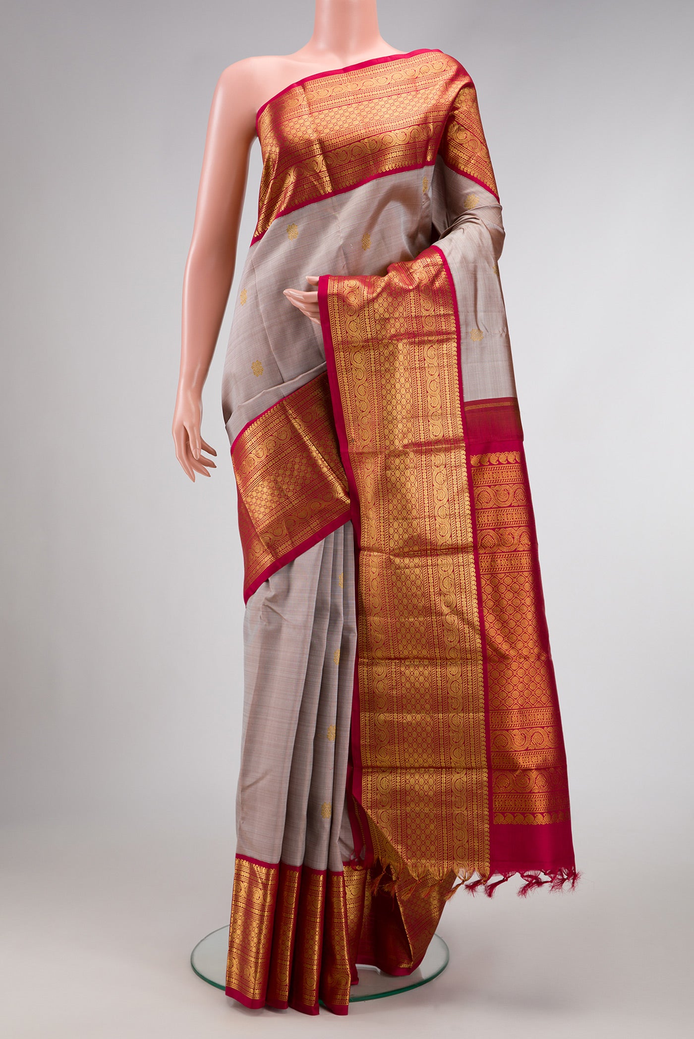 Dark Beige Dual Tone Kanjivaram Silk Saree with Zari Butta on the body and Zari Border.  displayed on a mannequin