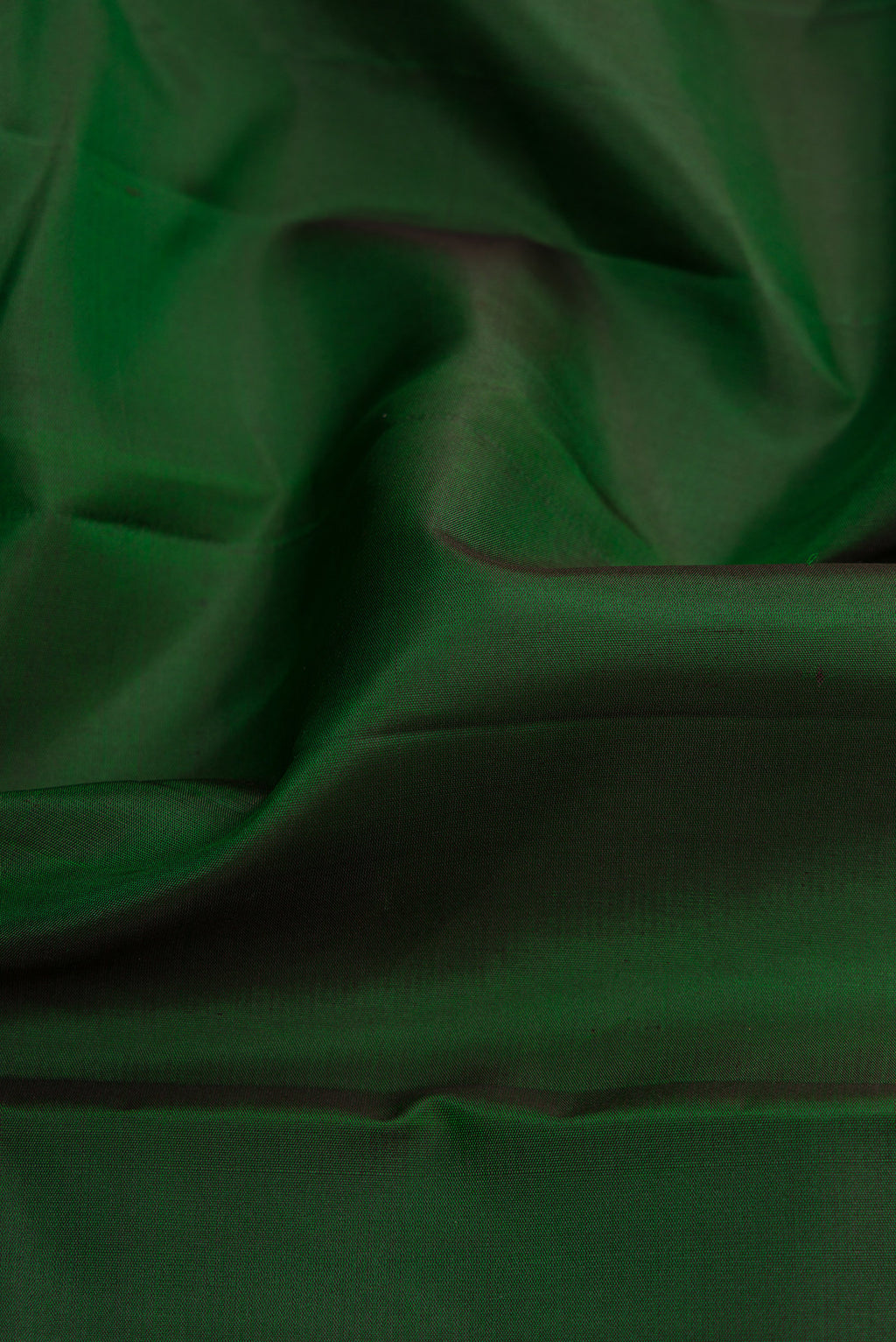 Close up of Bottle Green Dual Tone Kanjivaram Silk Saree with Plain Body and Zari Border.  displaying folds