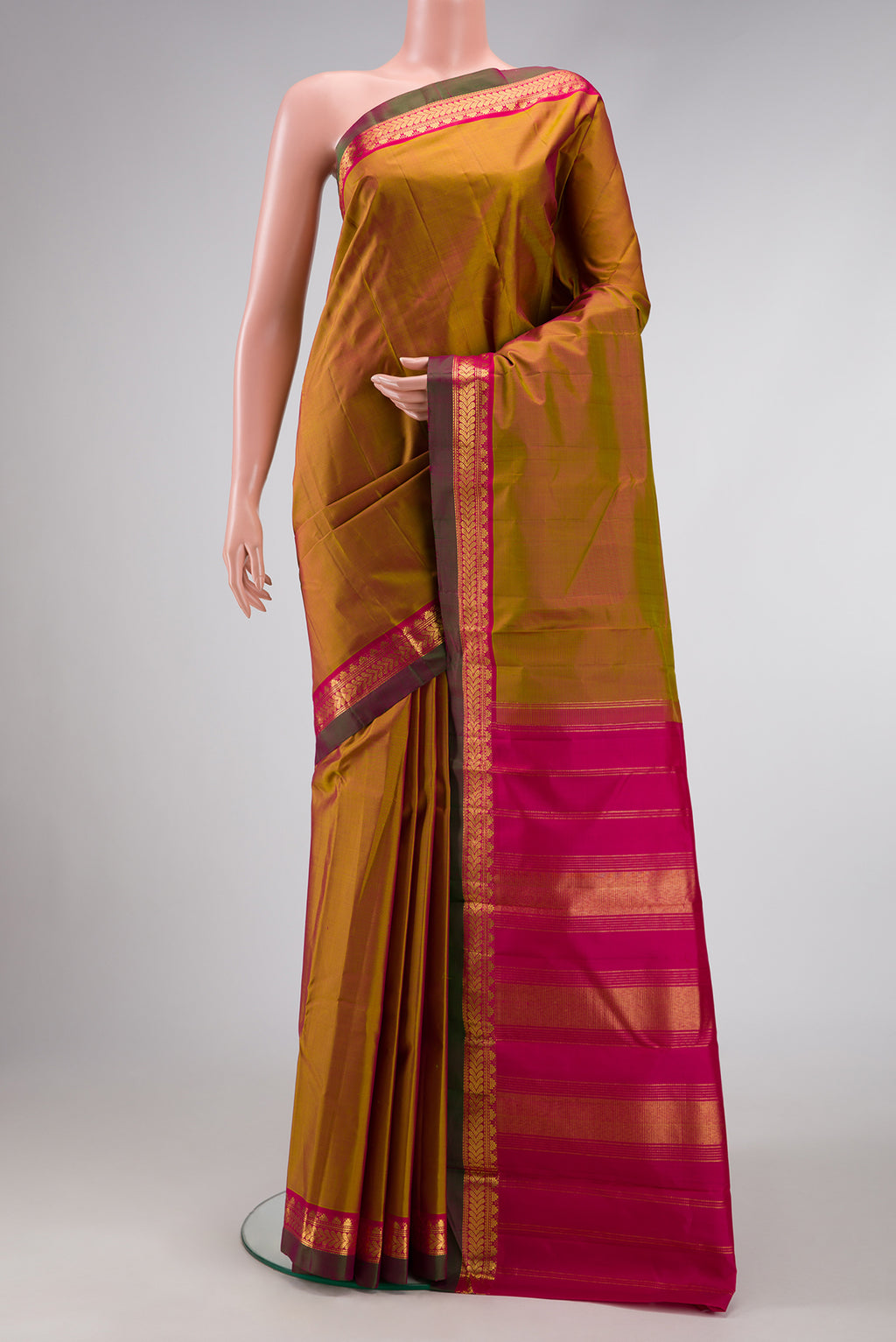 Pure Silk Pure Zari Mehandi Green Dual Tone Kanjivaram Saree with Plain Body and Zari Border.  displayed on a mannequin
