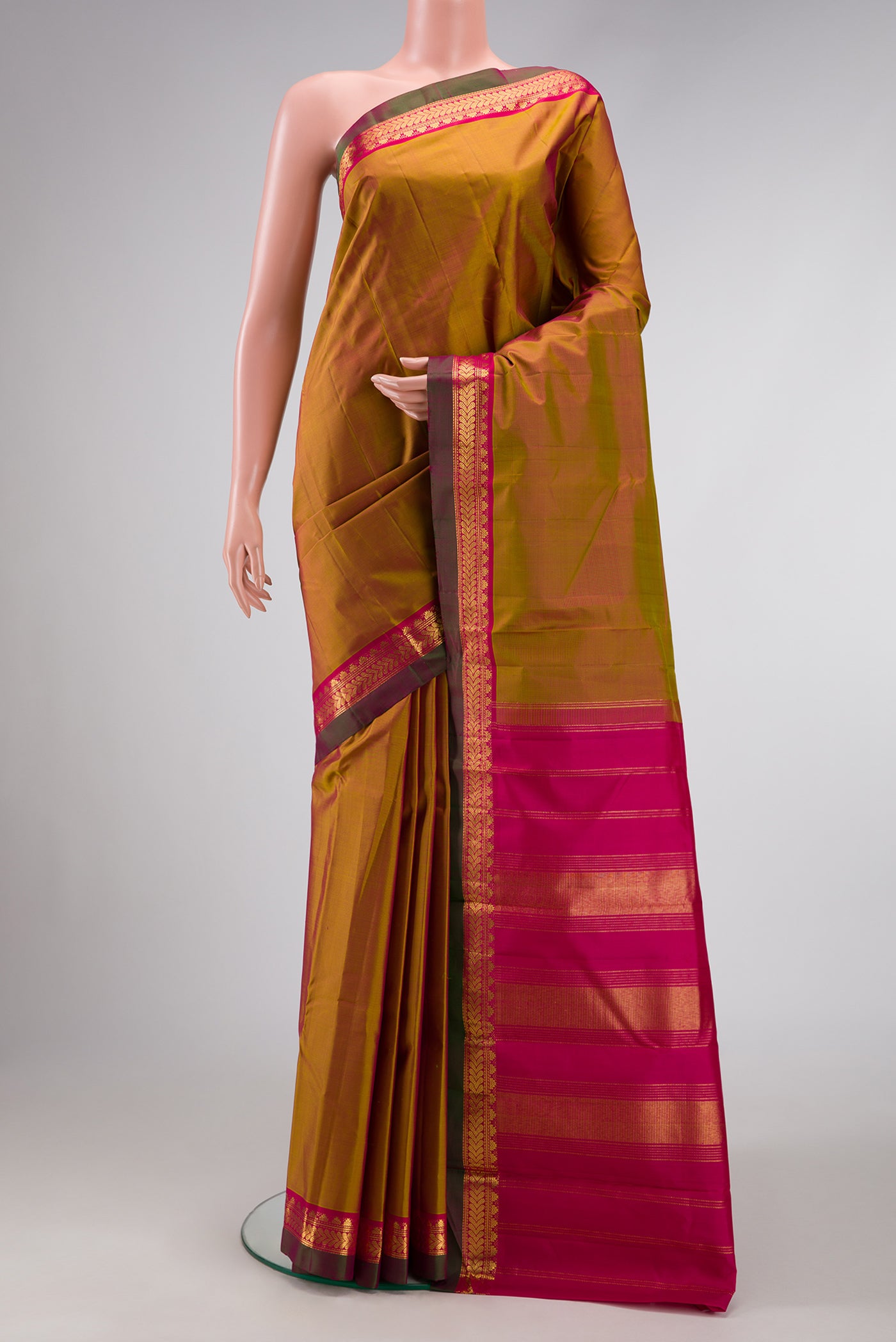 Pure Silk Pure Zari Mehandi Green Dual Tone Kanjivaram Saree with Plain Body and Zari Border.  displayed on a mannequin