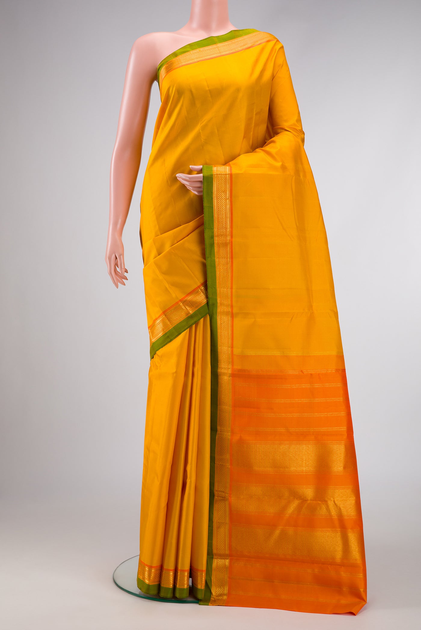 Yellow Dual Tone Kanjivaram Silk Saree with Plain Body and Zari Border.  displayed on a mannequin