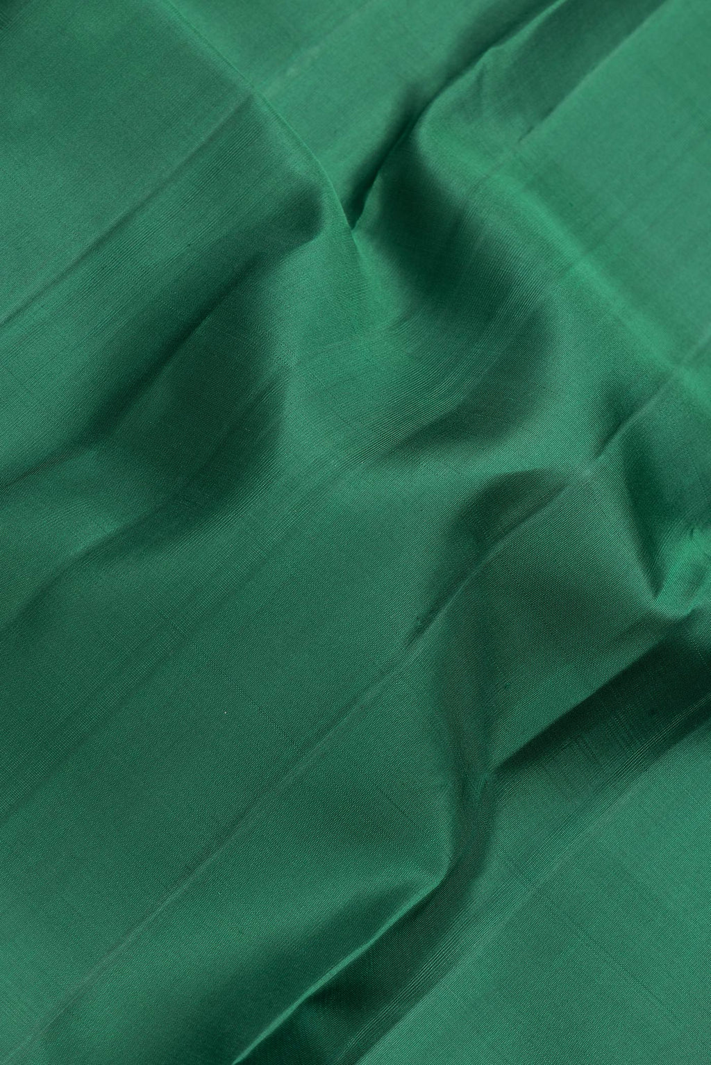 Close up of Bottle Green Dual Tone Kanjivaram Silk Saree with Plain Body and Zari Border.  displaying folds