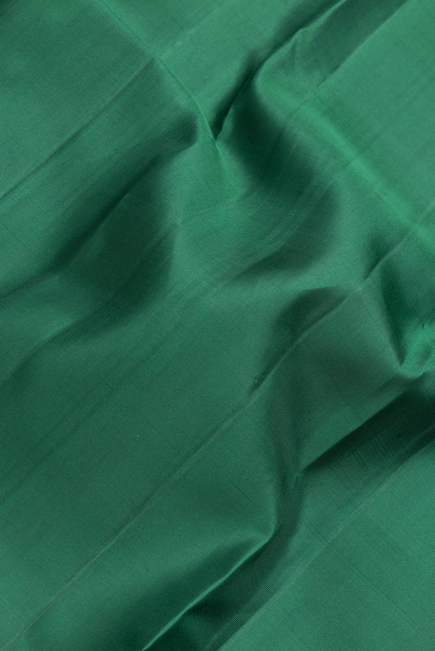 Close up of Bottle Green Dual Tone Kanjivaram Silk Saree with Plain Body and Zari Border.  displaying folds