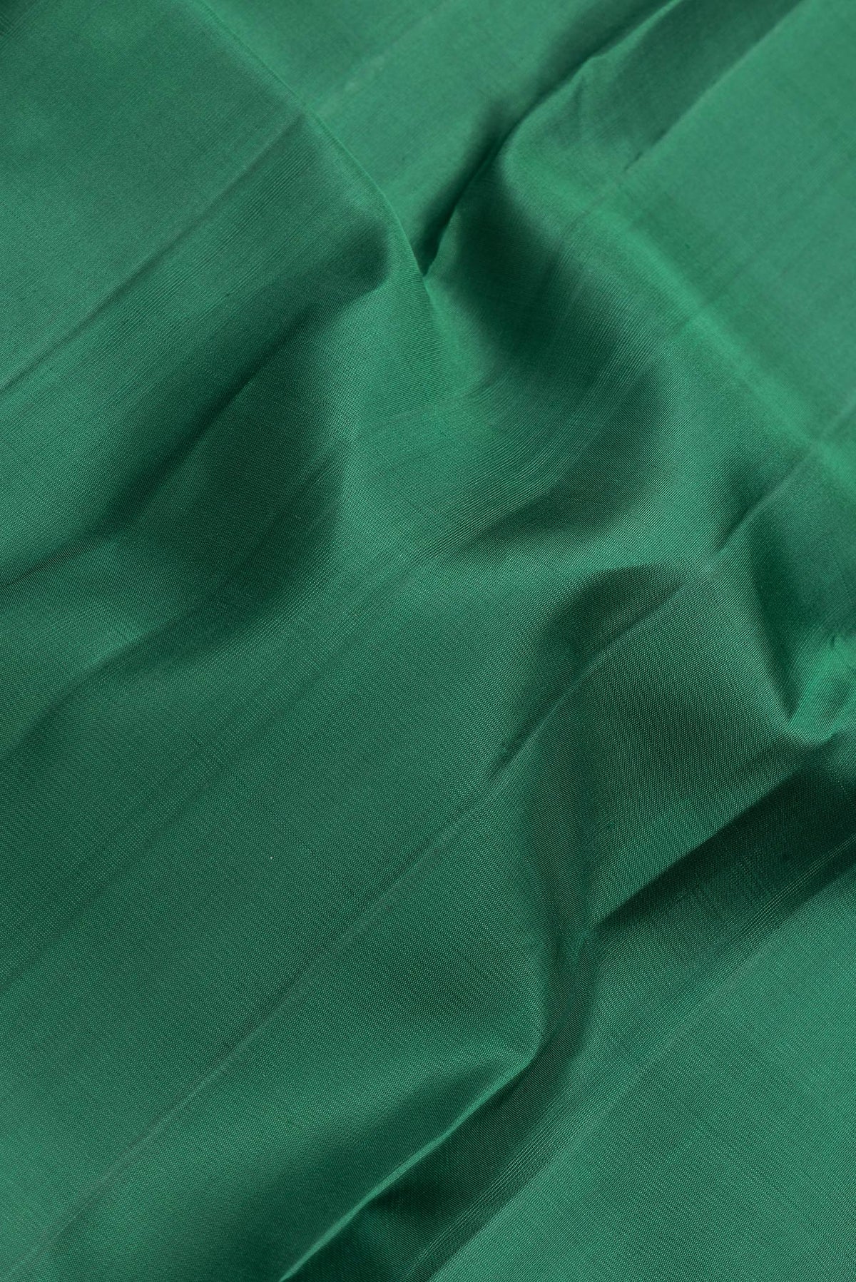 Close up of Bottle Green Dual Tone Kanjivaram Silk Saree with Plain Body and Zari Border.  displaying folds