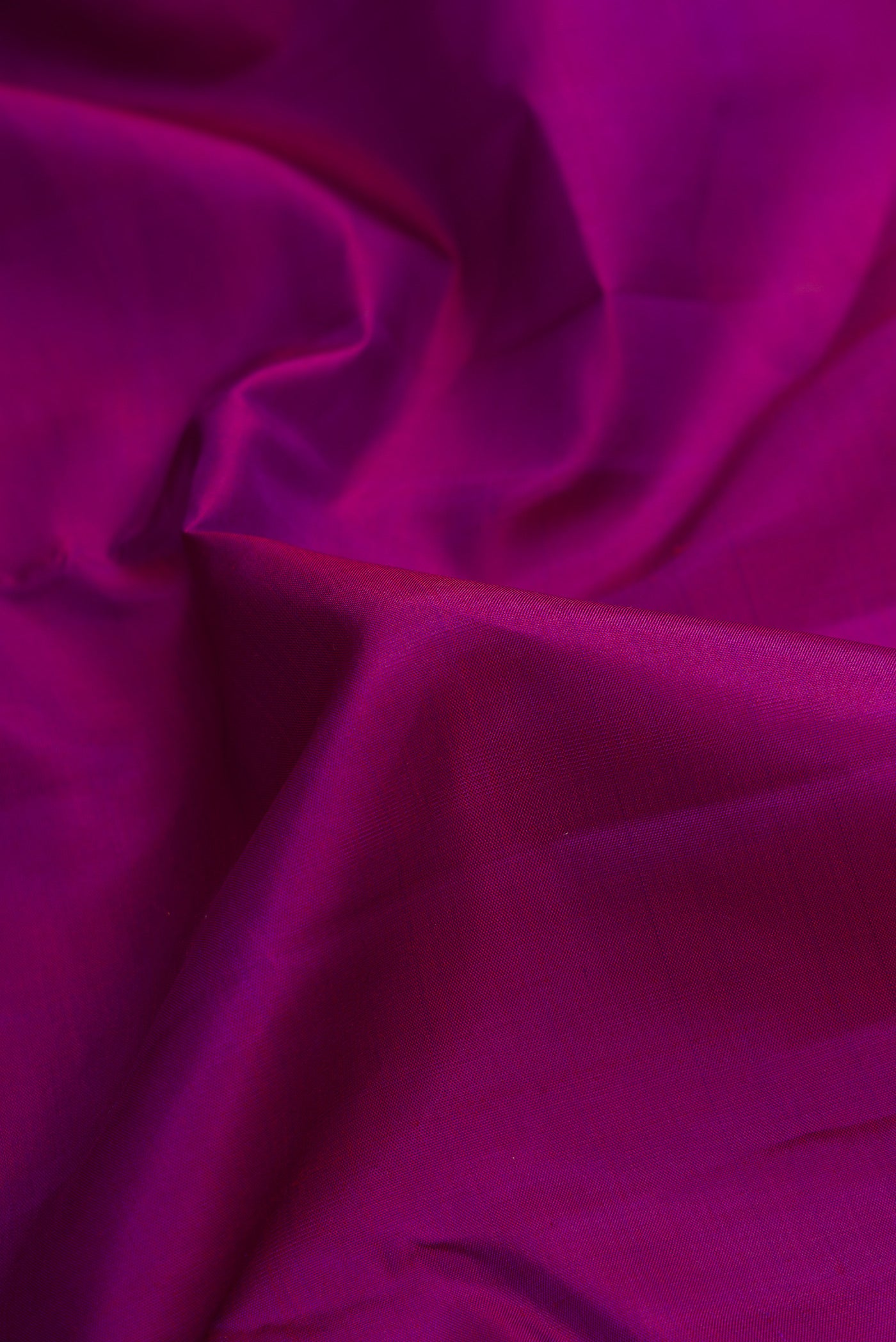 Close up of Pure Silk Pure Zari Purple Dual Tone Kanjivaram Saree with Plain Body and Zari Border.  displaying folds