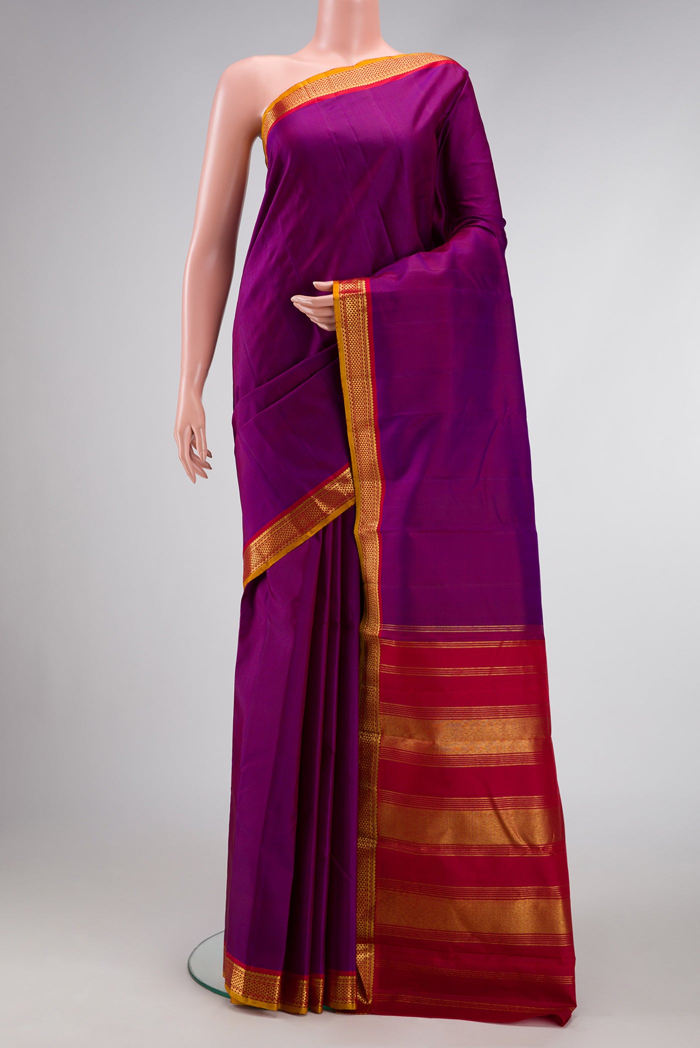 Pure Silk Pure Zari Purple Dual Tone Kanjivaram Saree with Plain Body and Zari Border.  displayed on a mannequin