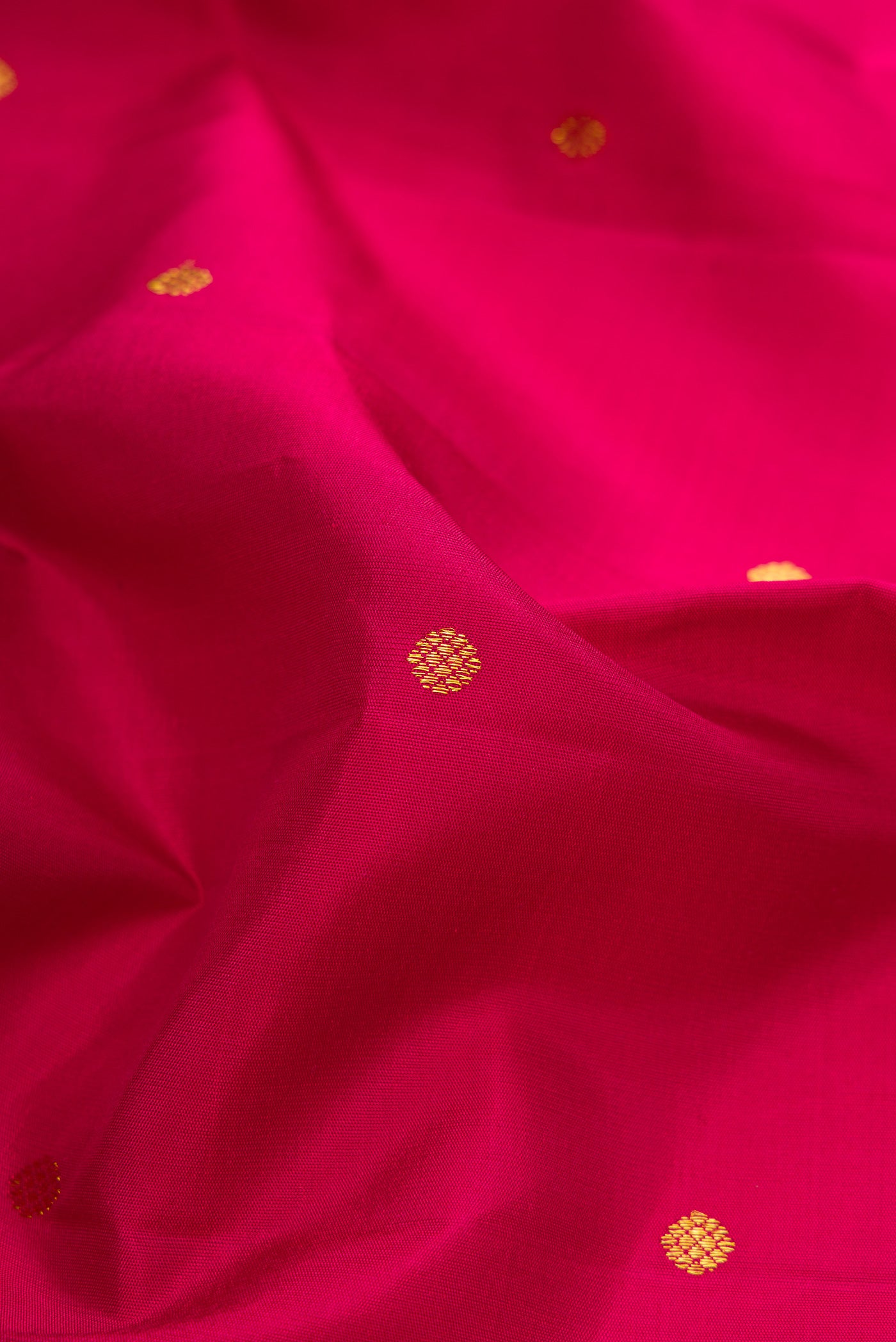 Close up of Dark Mauve Dual Tone Kanchipuram Silk Saree with Zari Butta on the body and Zari Border.  displaying folds