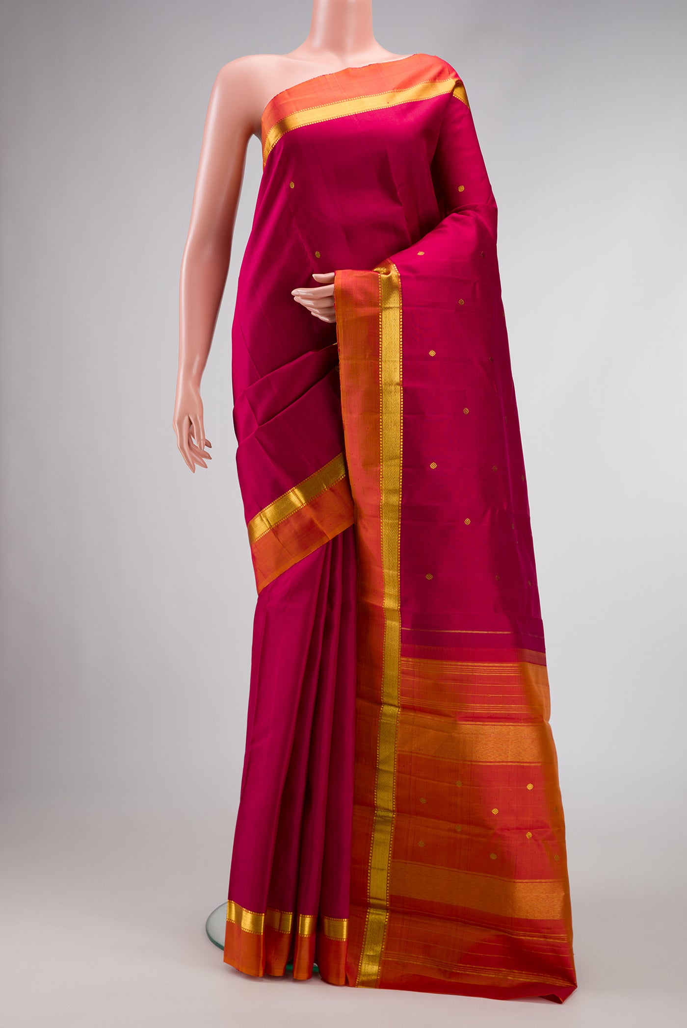 Dark Mauve Dual Tone Kanchipuram Silk Saree with Zari Butta on the body and Zari Border.  displayed on a mannequin