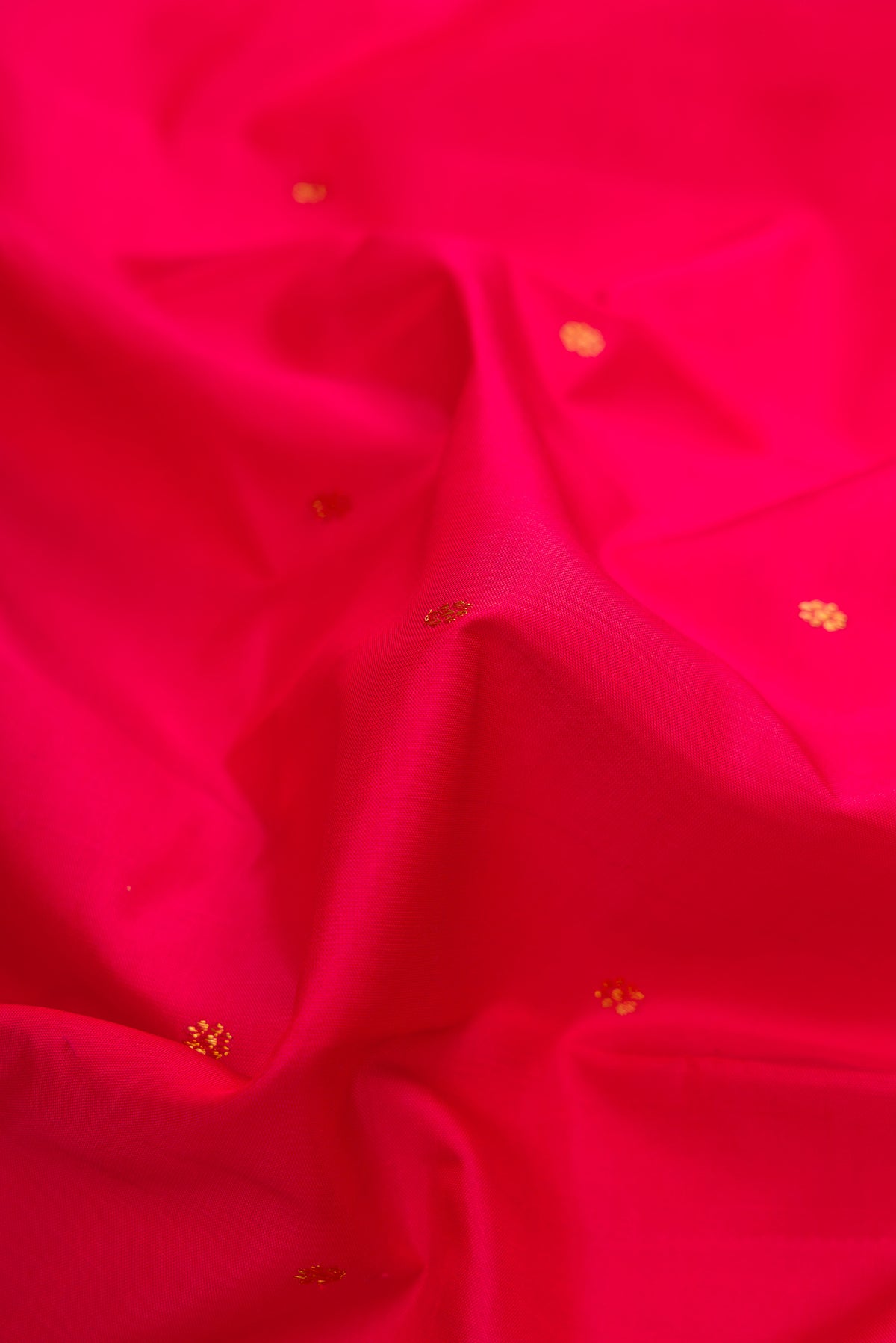 Close up of Red Dual Tone Kanchipuram Silk Saree with Zari Butta on the body and Zari Border.  displaying folds