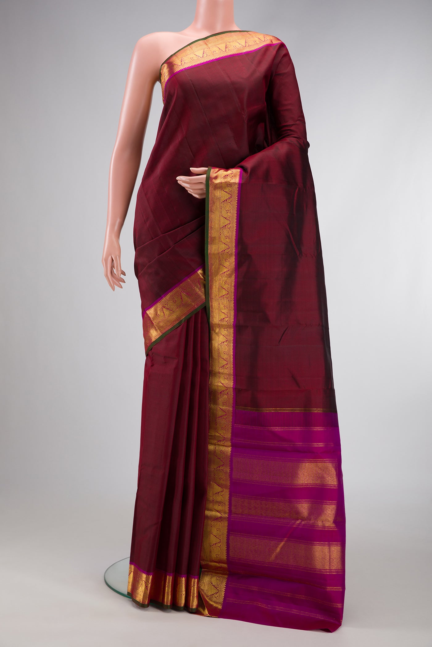 Maroon Dual Tone Kanchipuram Silk Saree with Plain Body and Zari Border.  displayed on a mannequin