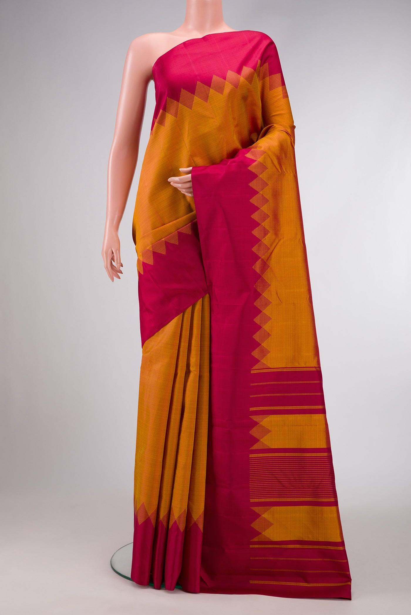 Mustard Dual Tone Kanjivaram Silk Saree with Plain Body and Fancy Border.  displayed on a mannequin