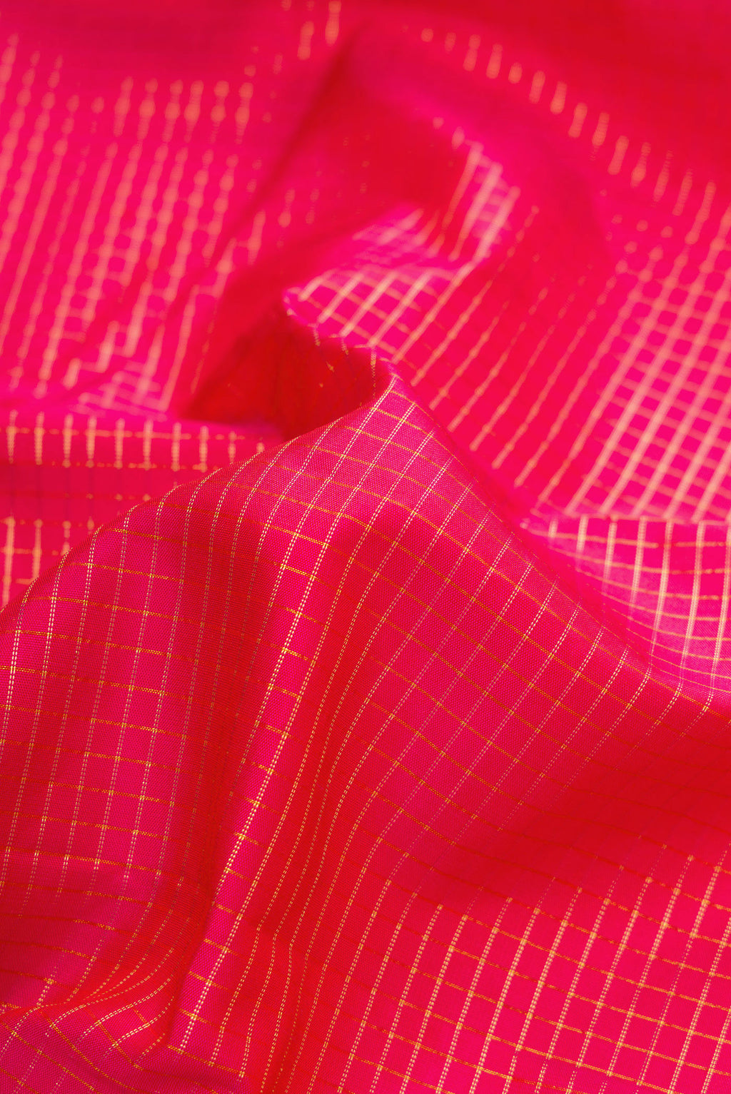 Close up of Pink Dual Tone Kanjivaram Silk Saree with Checked design on the body and Zari Border.  displaying folds