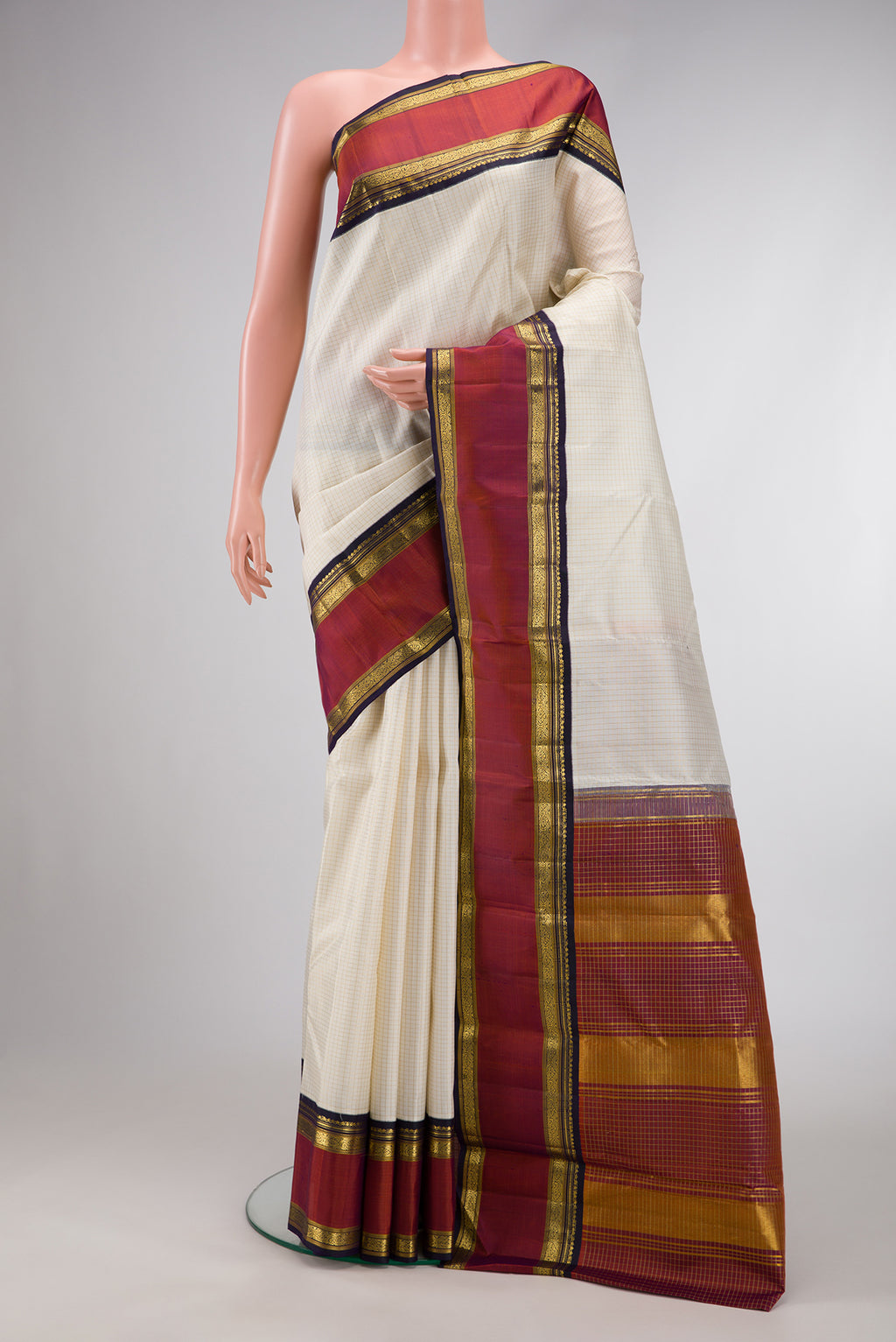 Off White Dual Tone Kanjivaram Silk Saree with Checked design on the body and Zari Border.  displayed on a mannequin