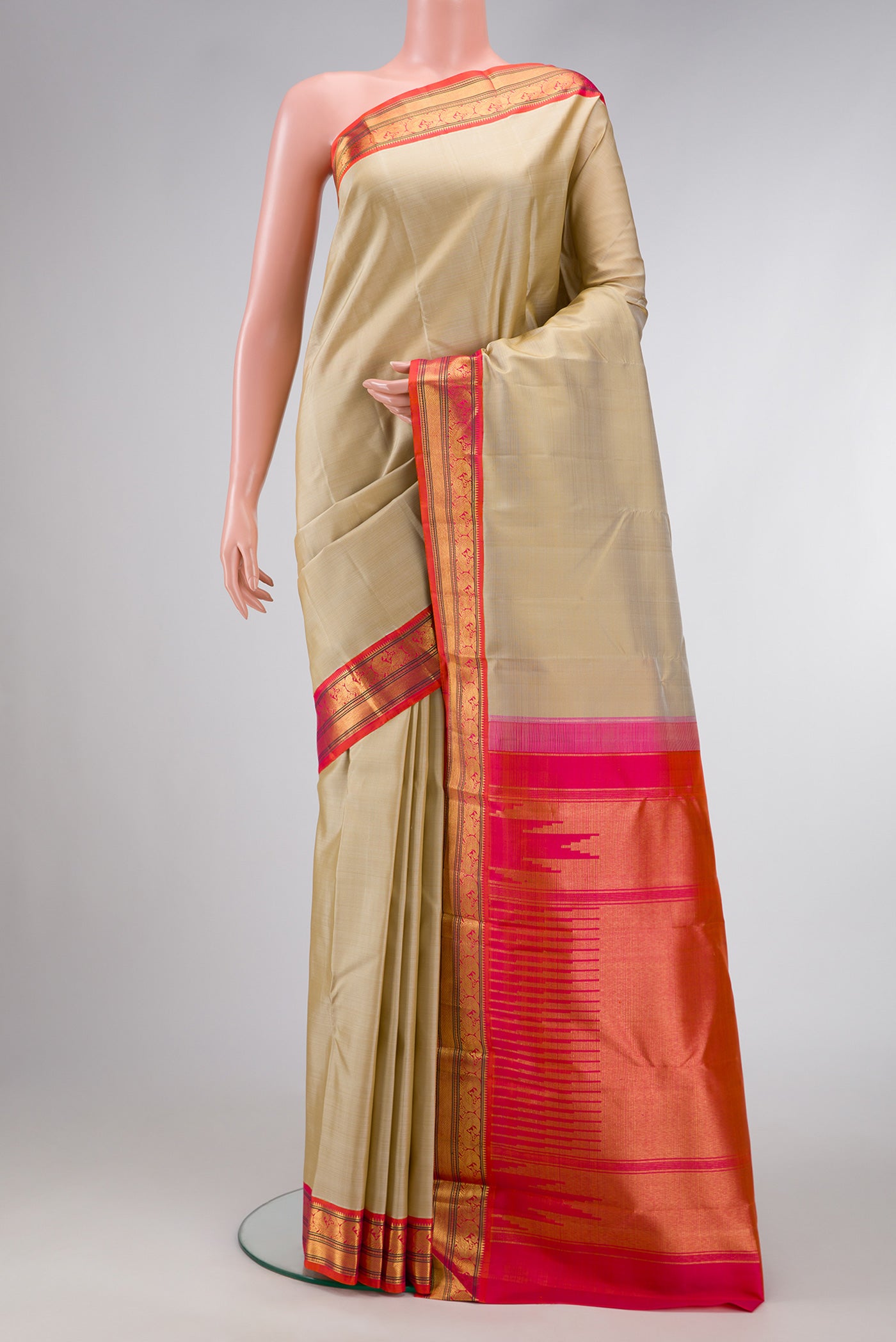 Beige Dual Tone Kanjivaram Silk Saree with Zari Butta on the body and Zari Border.  displayed on a mannequin
