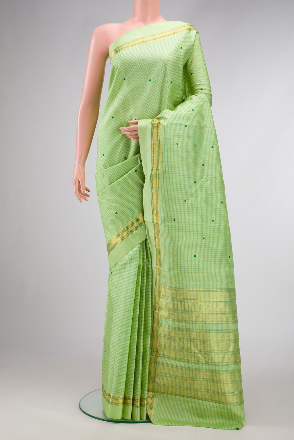 Parrot Green Dual Tone Kanjivaram Silk Saree with Checked design on the body and Zari And Thread Border.  displayed on a mannequin
