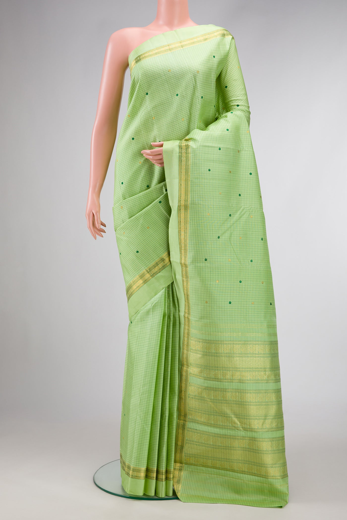Parrot Green Dual Tone Kanjivaram Silk Saree with Checked design on the body and Zari And Thread Border.  displayed on a mannequin