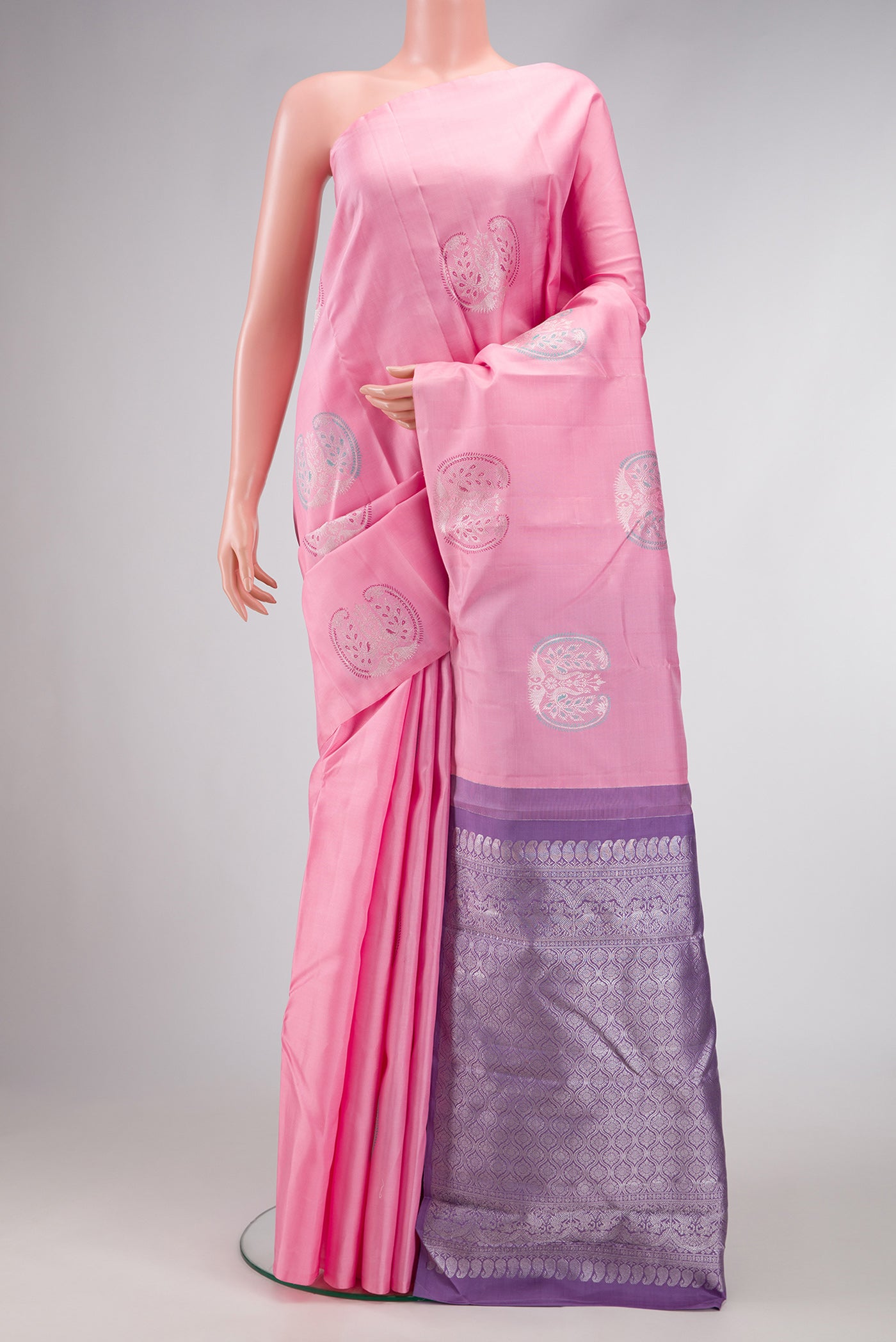 Pink Dual Tone Kanjivaram Silk Saree with Zari And Thread Butta on the body and Without Border.  displayed on a mannequin