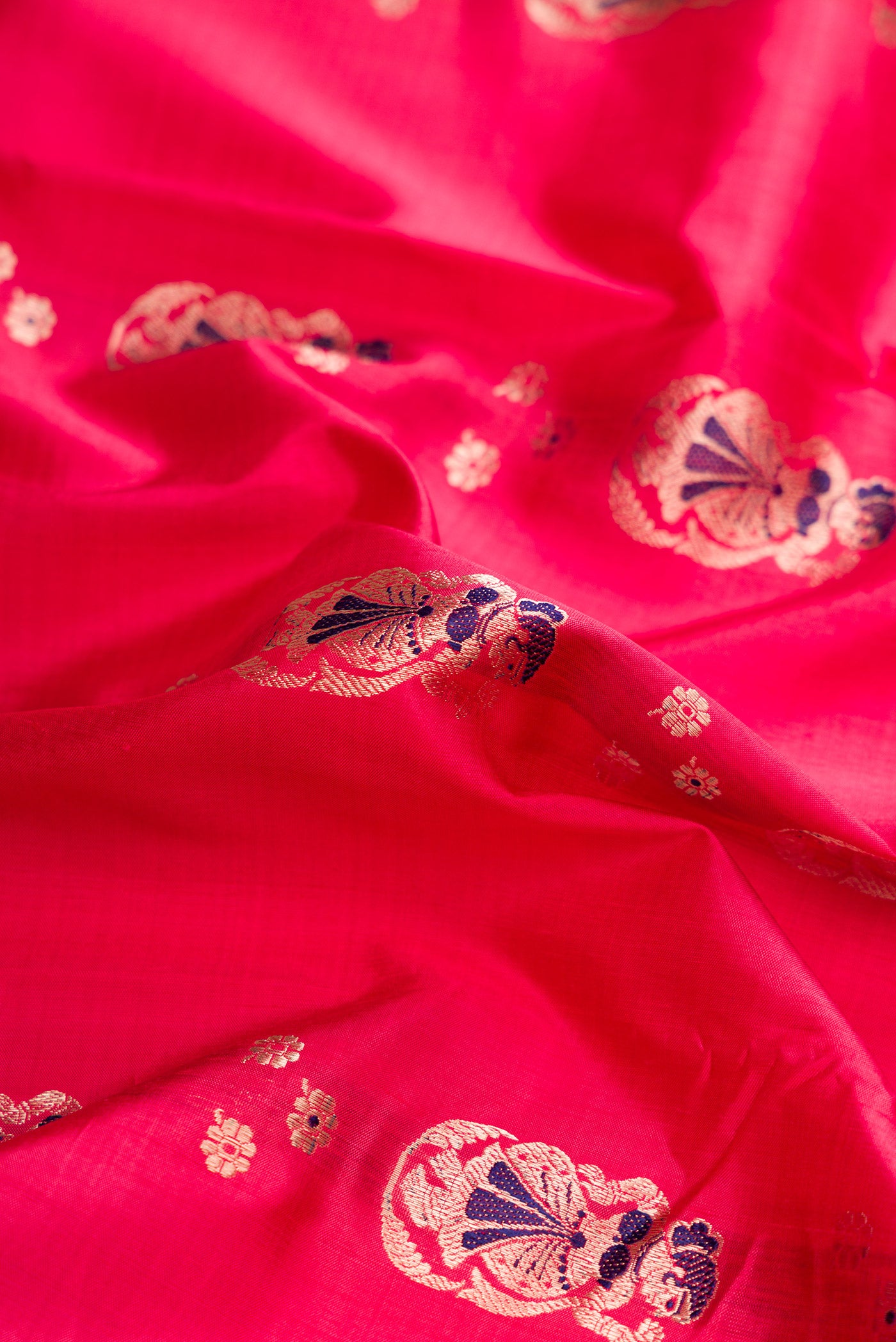 Close up of Pink Dual Tone Baluchari Silk Saree with Zari And Thread Butta on the body and Zari Border.  displaying folds