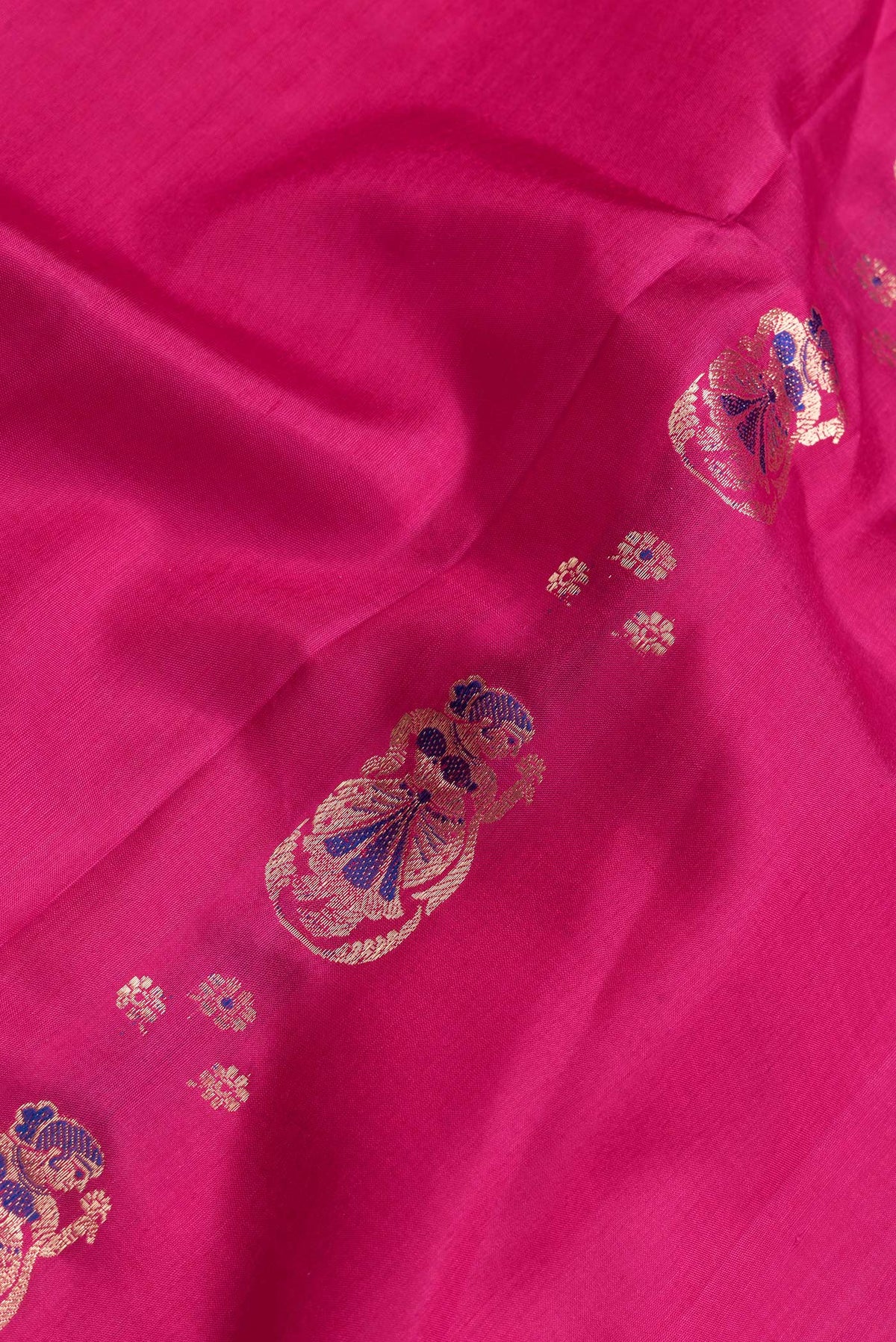 Close up of Pink Dual Tone Baluchari Silk Saree with Zari And Thread Butta on the body and Fancy Border.  displaying folds