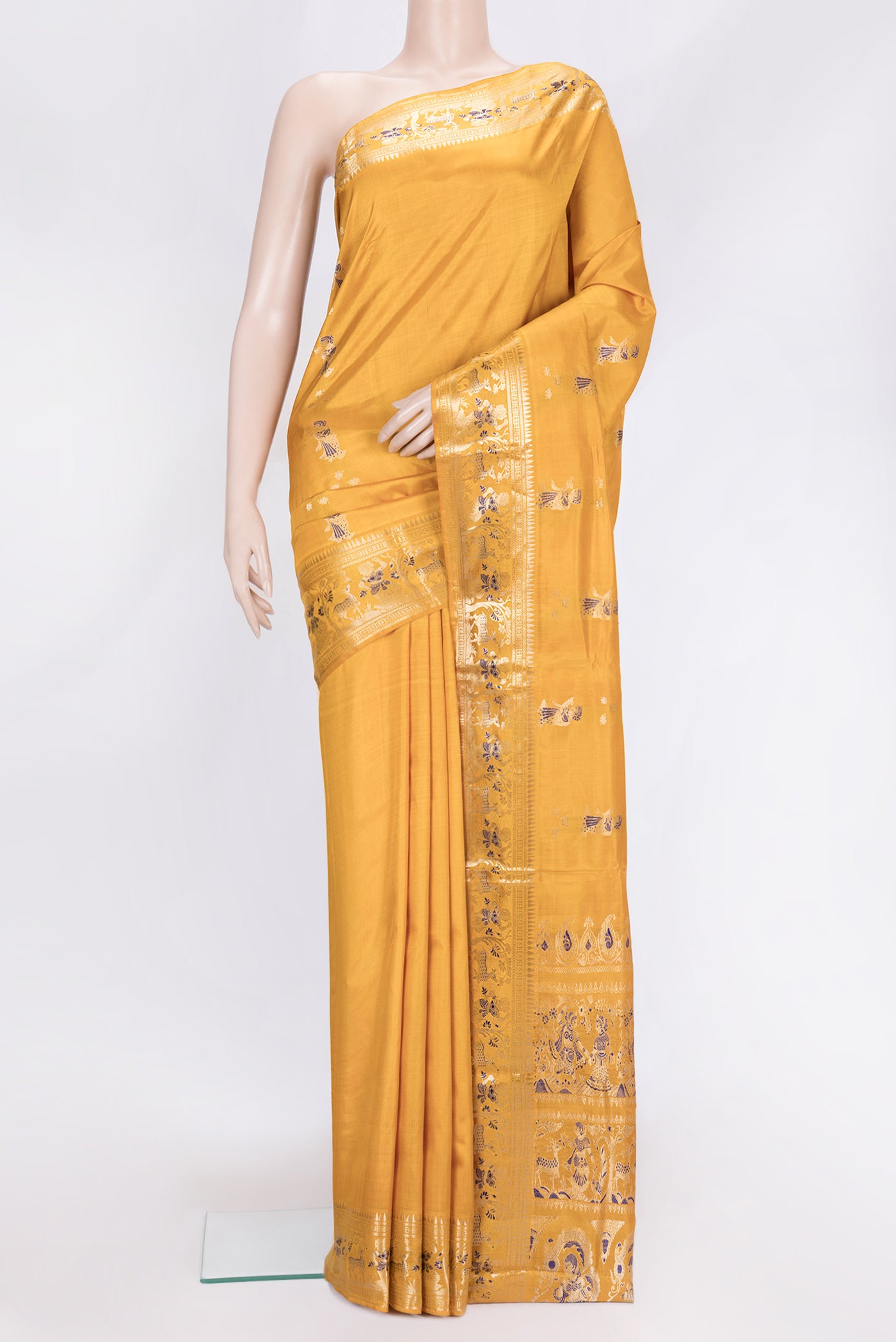 Mustard Dual Tone Baluchari Silk Saree with Zari And Thread Butta on the body and Fancy Border.  displayed on a mannequin