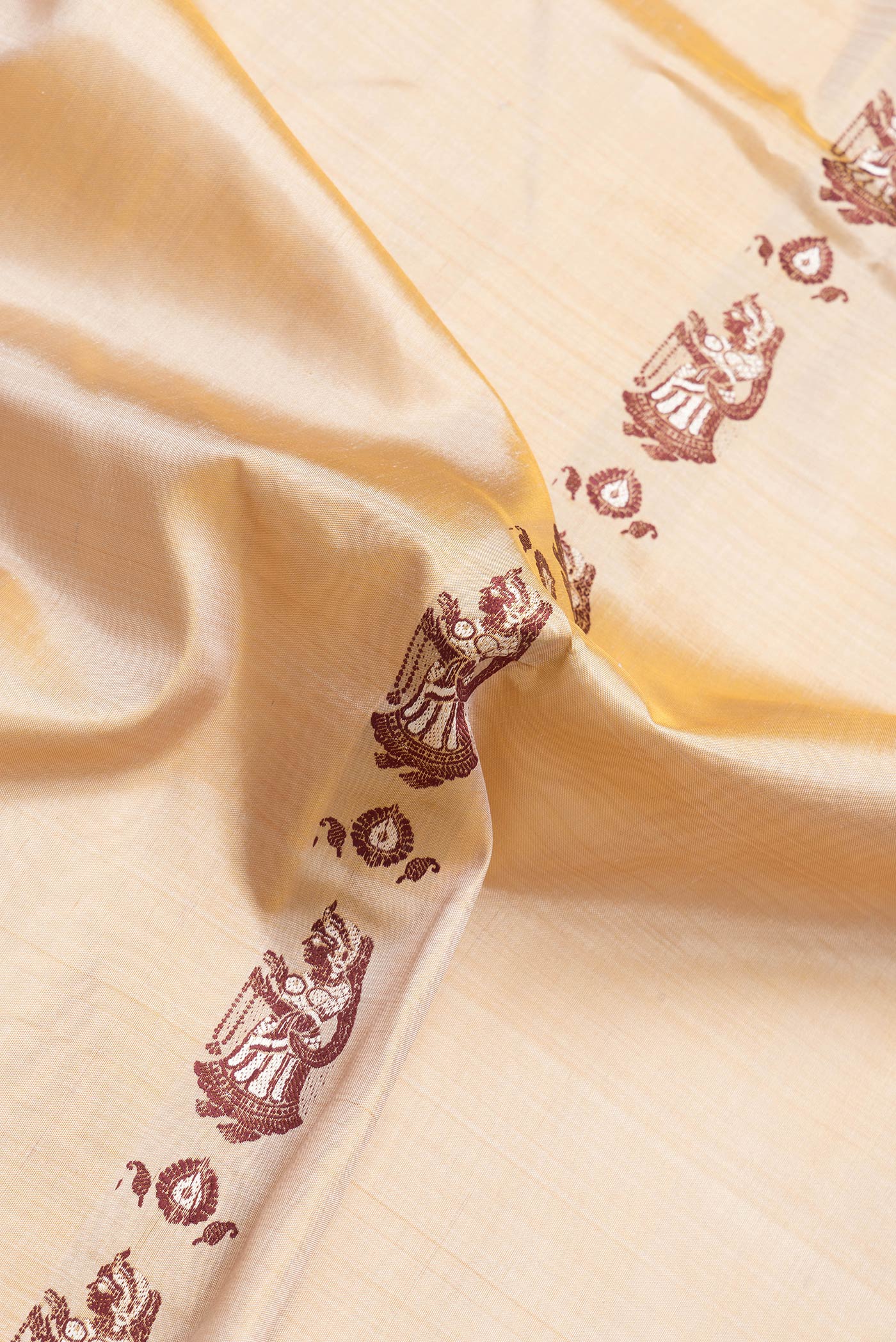 Close up of Dark Beige Dual Tone Baluchari Silk Saree with Thread Butta on the body and Thread Border.  displaying folds