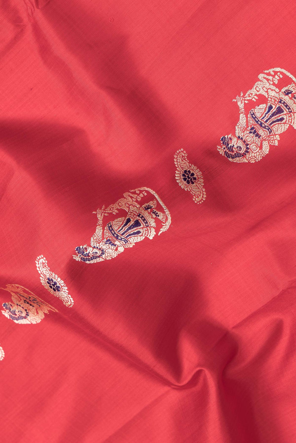 Close up of Red Dual Tone Baluchari Silk Saree with Thread Butta on the body and Fancy Border.  displaying folds