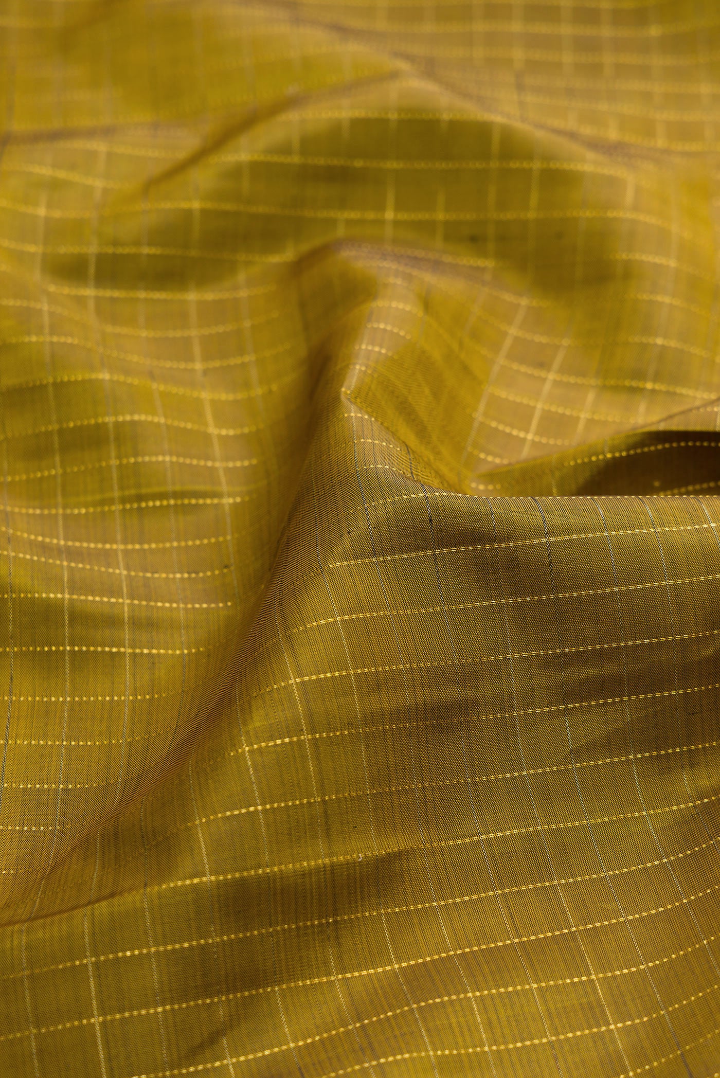 Close up of Mehandi Green Dual Tone Kanjivaram Silk Saree with Checked design on the body and Ganga Jamuna Border.  displaying folds