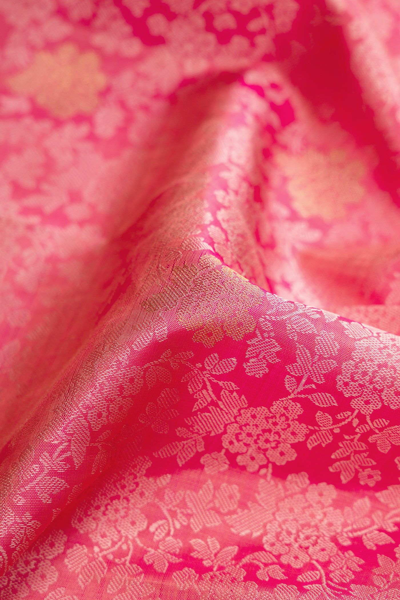 Close up of Pink Dual Tone Kanchipuram Silk Saree with Jacquard With Zari Butta on the body and Zari Border.  displaying folds