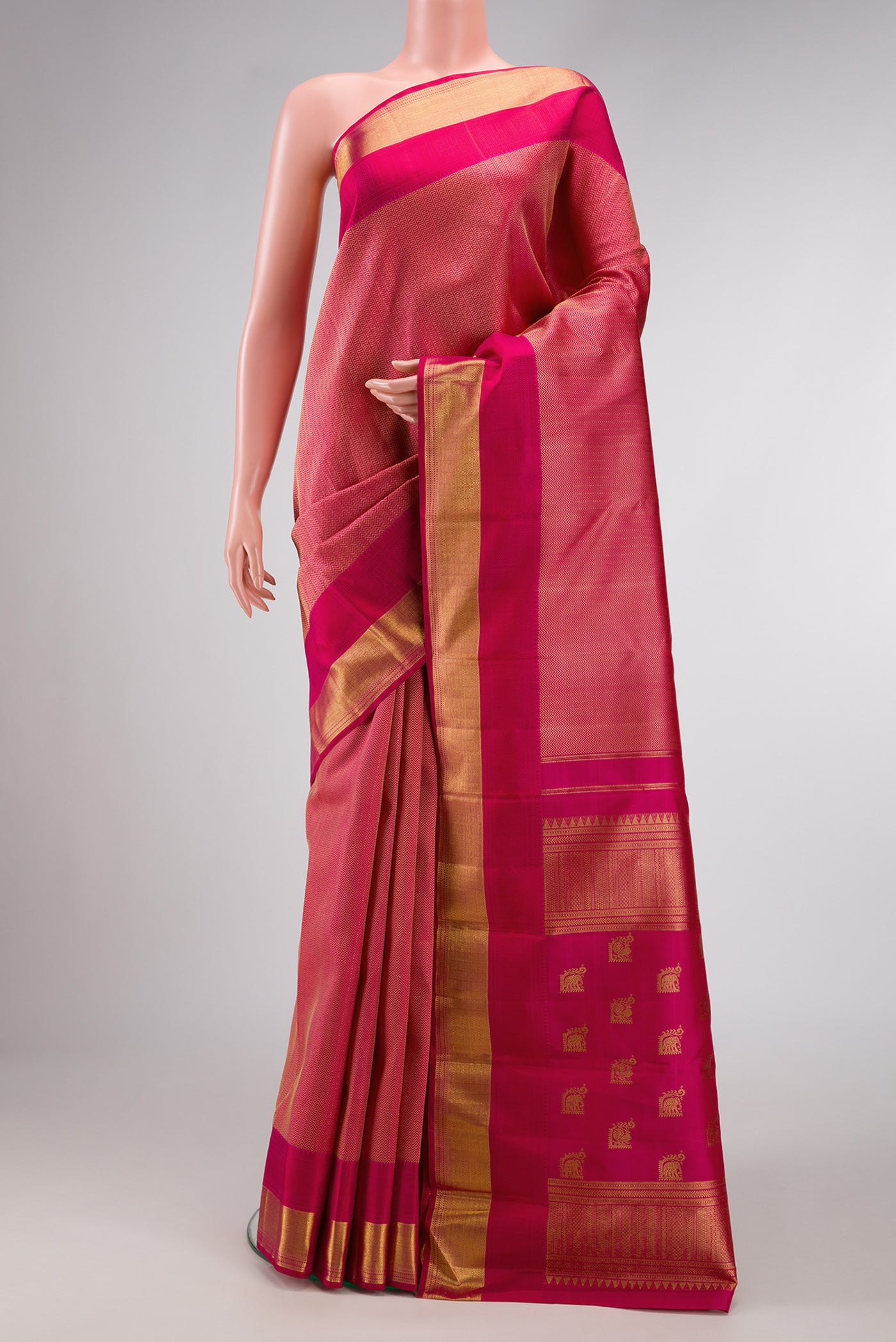 Dark Pink Dual Tone Kanchipuram Silk Saree with Jacquard design on the body and Zari Border.  displayed on a mannequin