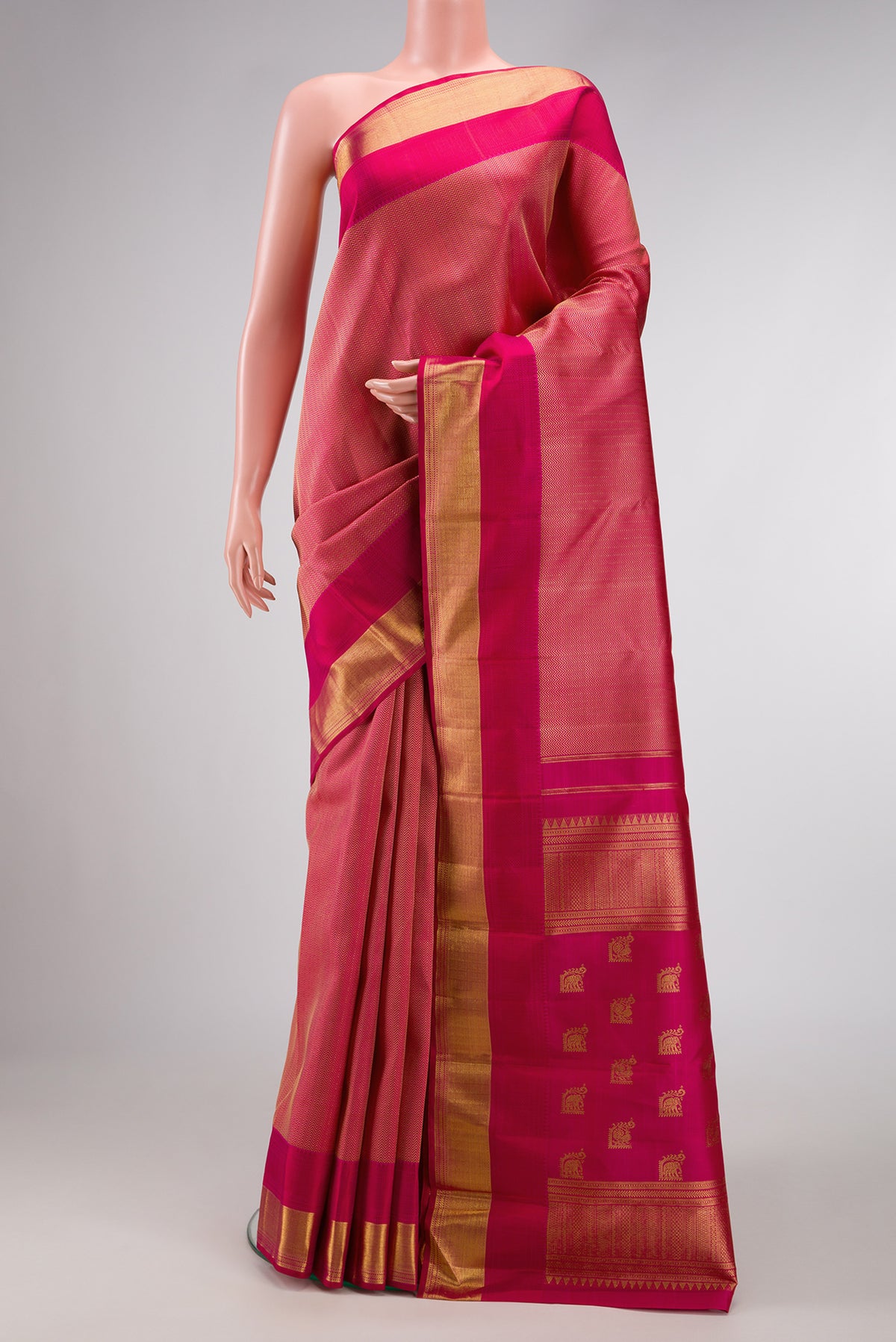 Dark Pink Dual Tone Kanchipuram Silk Saree with Jacquard design on the body and Zari Border.  displayed on a mannequin
