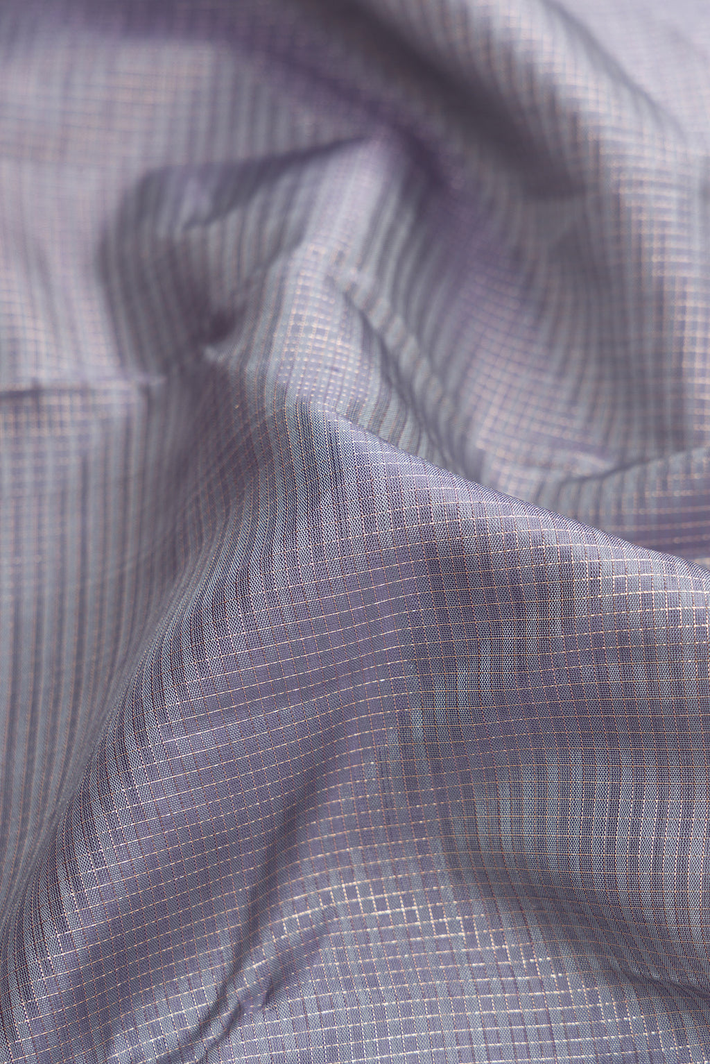 Close up of Grey Dual Tone Kanjivaram Silk Saree with Zari Butta on the body and Zari Border.  displaying folds