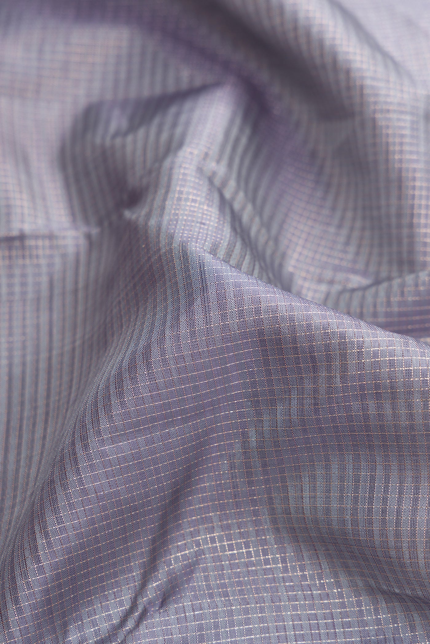 Close up of Grey Dual Tone Kanjivaram Silk Saree with Zari Butta on the body and Zari Border.  displaying folds