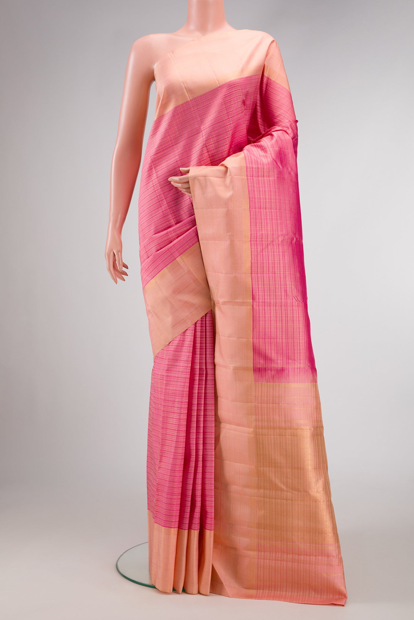 Pink Dual Tone Kanjivaram Silk Saree with Stripes on the body and Zari Border.  displayed on a mannequin